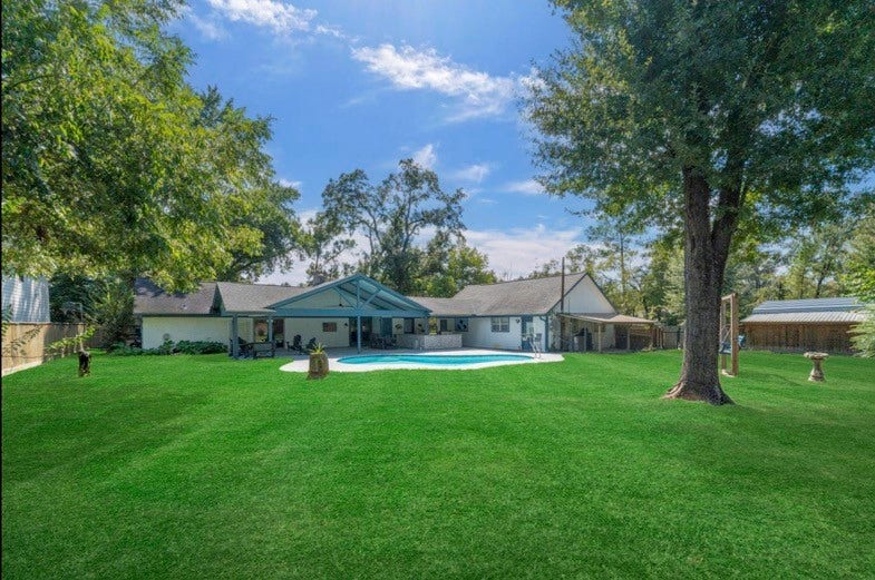 12710 Mutiny Lane, Tomball, TX 77377 Expansive lawn and mature trees offer room to enjoy this lot of more than half an acre.
