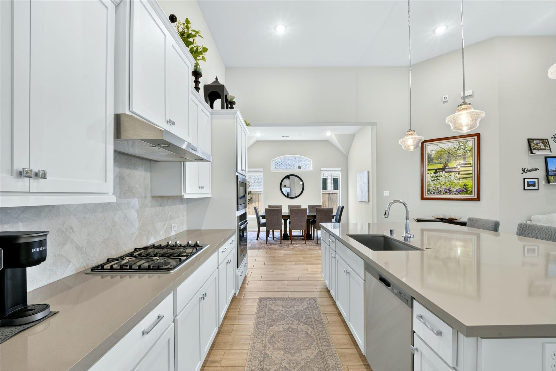11351 Cosmopolitan Drive, Cypress, TX 77433 This kitchen was made for connection. A gas cooktop, built-in oven and microwave make cooking effortless, while the oversized sink handles it all with ease. Crisp white cabinets brighten the space, and an open view to the dining room means you are never far from conversation.