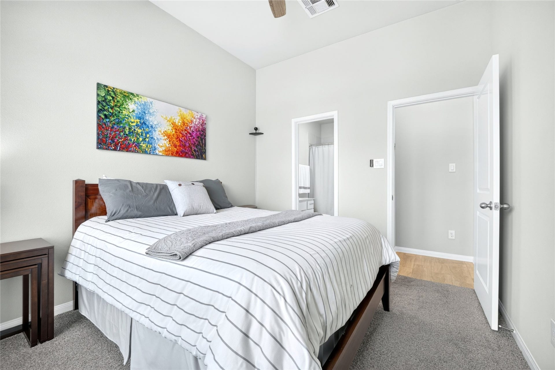 11351 Cosmopolitan Drive, Cypress, TX 77433 One of the front bedrooms featuring stylish en-suite bath, single vanity, soaking tub, designer mirror and spacious walk-in closet. Sophisticated gray tones create serene retreat.