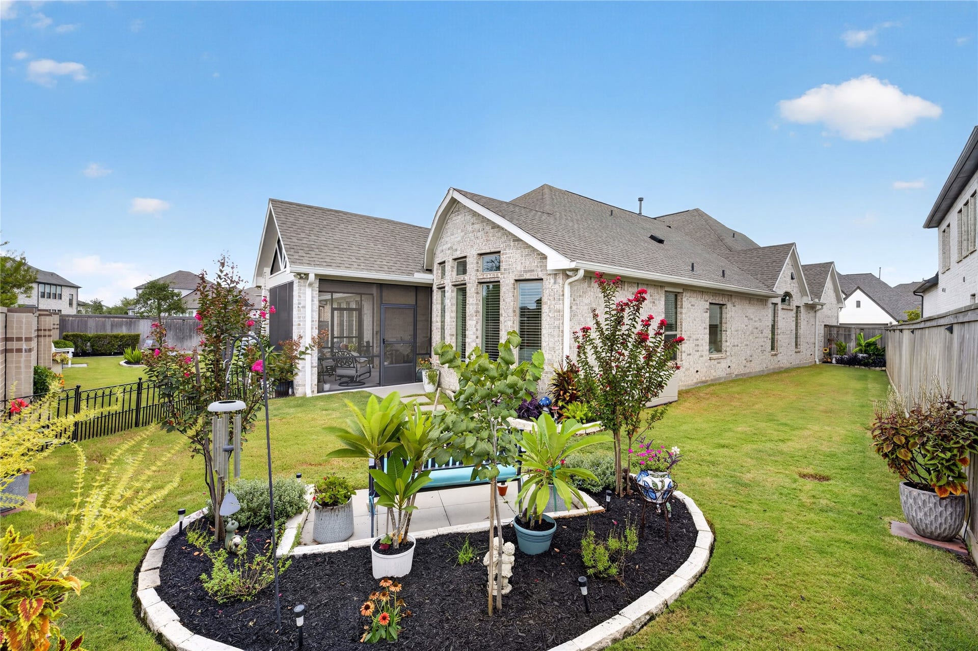 11351 Cosmopolitan Drive, Cypress, TX 77433 Beautifully landscaped backyard with spacious areas, mature plantings and a charming garden bed.