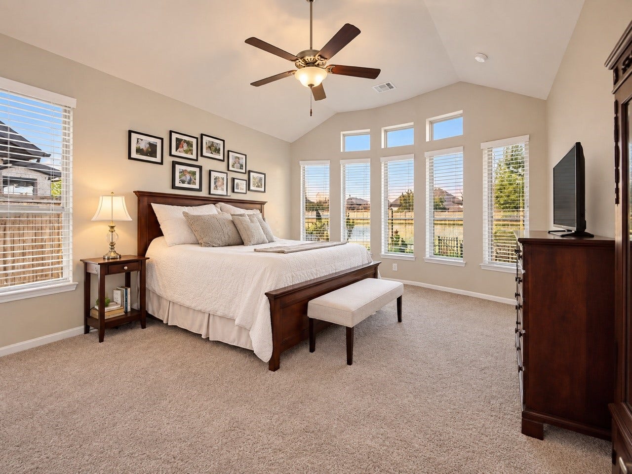 11351 Cosmopolitan Drive, Cypress, TX 77433 Spacious primary bedroom tucked at the back of the home, offering peaceful backyard views, abundant windows, high ceilings, and beautiful natural light.