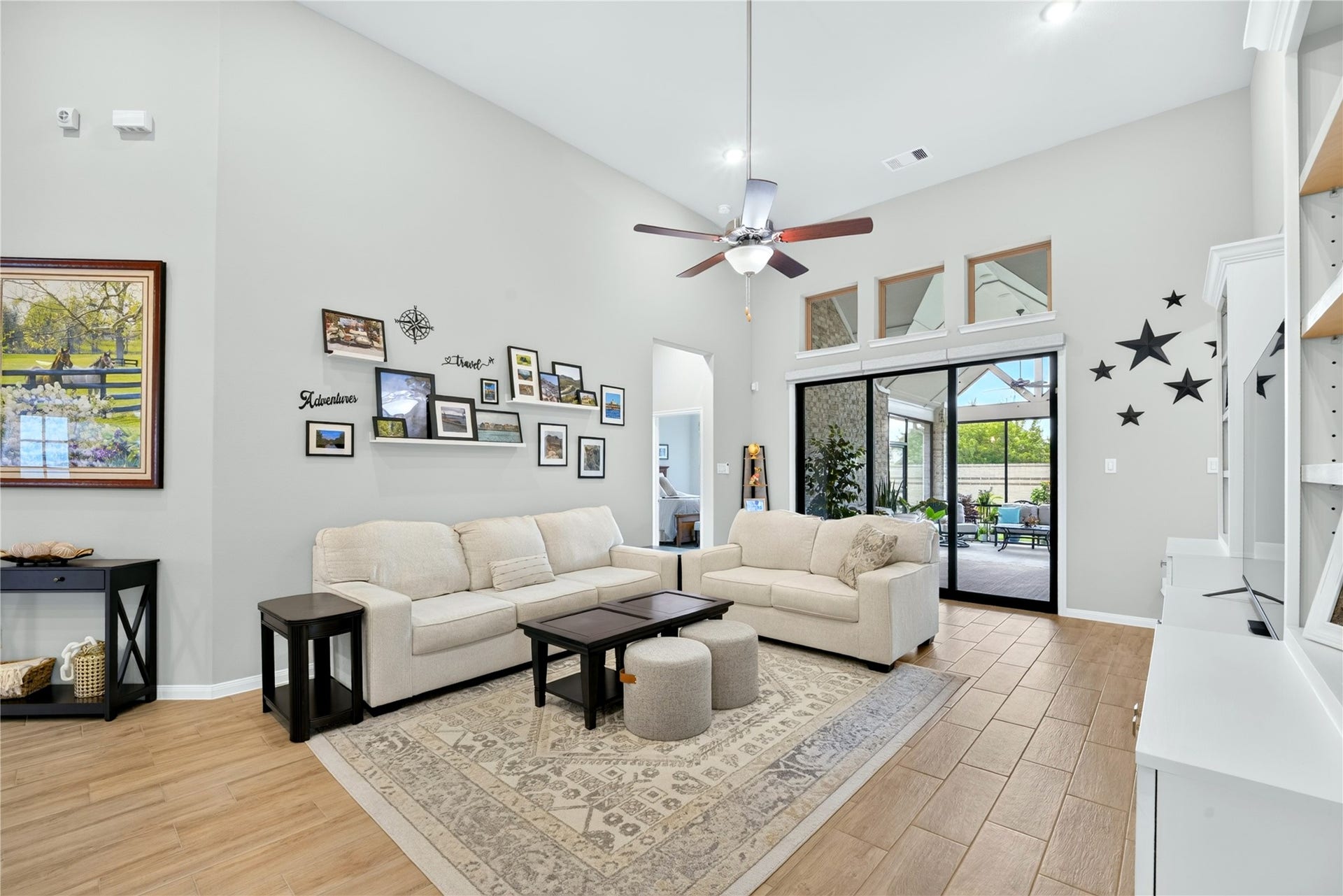 11351 Cosmopolitan Drive, Cypress, TX 77433 Bright and spacious living room featuring high ceilings, neutral paint, and tile flooring. Large sliding glass doors provide beautiful views of the covered patio.