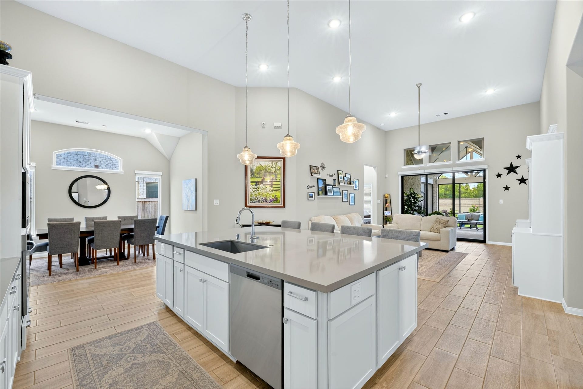 11351 Cosmopolitan Drive, Cypress, TX 77433 Beautifully designed Island Kitchen featuring an oversized granite countertop and soft neutral tones throughout. High Ceilings add airy, open feel, white cabinets surrounding the island including convenient pull out storage.