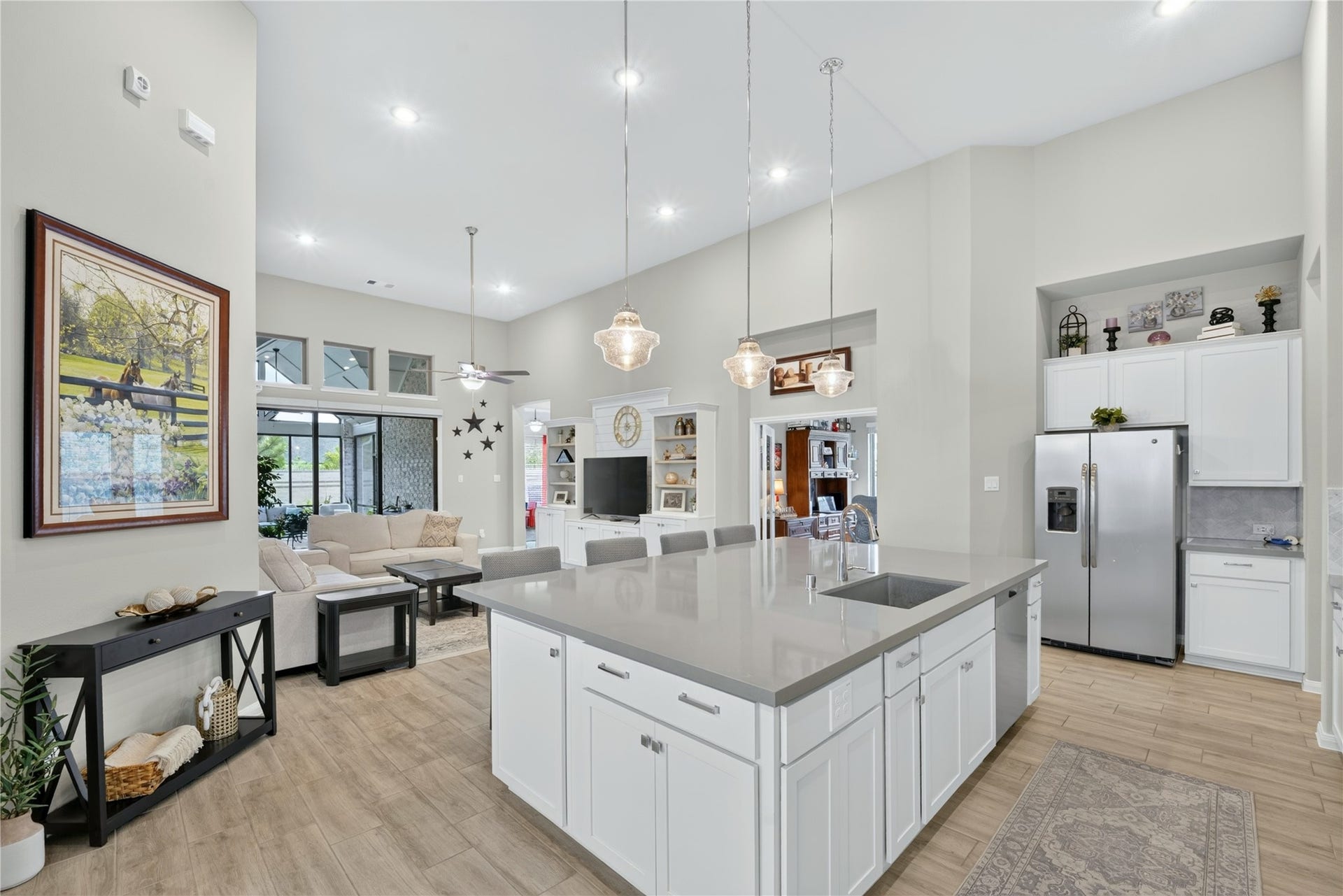 11351 Cosmopolitan Drive, Cypress, TX 77433 This beautifully oversized island kitchen is a chef's dream and an entertainer's delight. Crisp white cabinetry, elegant tile flooring, and soaring ceilings create a bright, open feel, while direct views to the covered outdoor patio keep space connected to the beauty just beyond the doors.