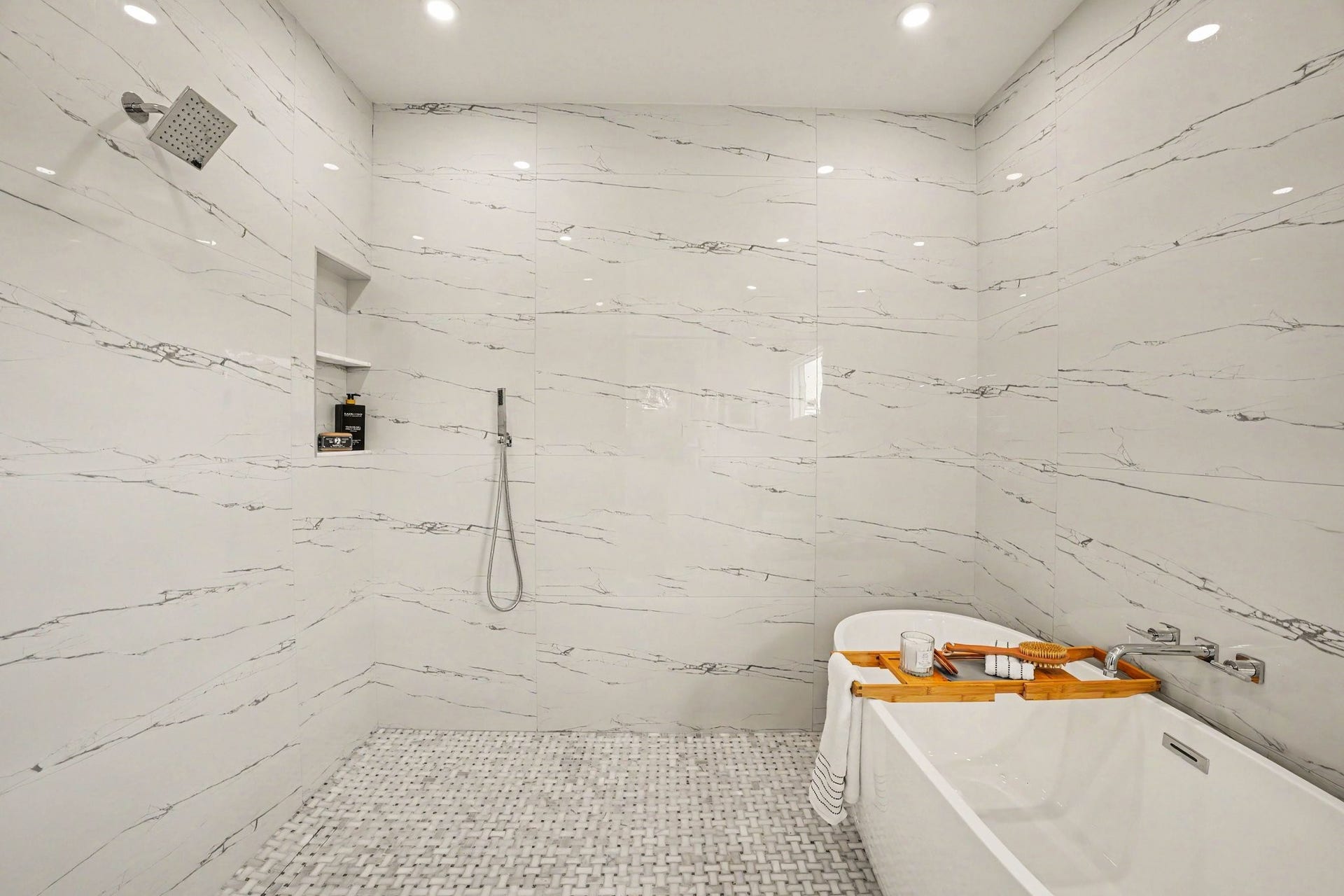 Step inside the wet room, complete with soaking tub, rain shower head, wall mounted shower head, and hand sprayer for added convenience.