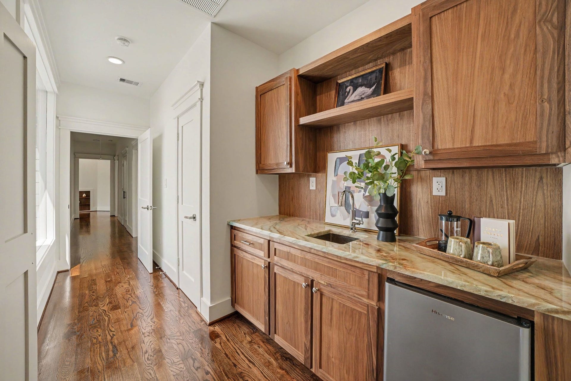 Wet bar included in the primary suite with sink and beverage fridge.
