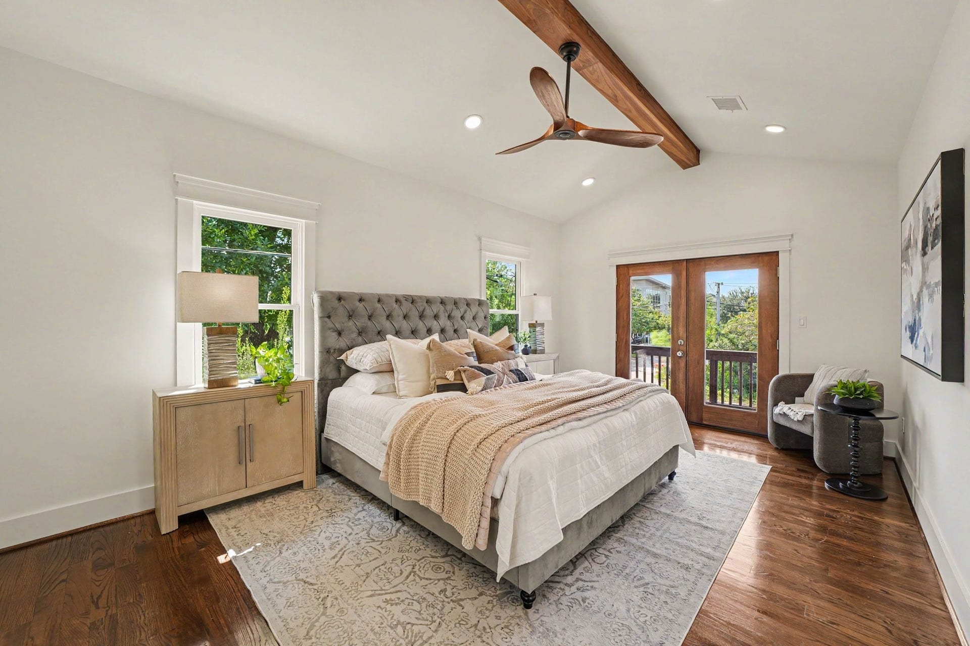 Spacious bedroom that fits a king bed, two nightstands, and even space for a sitting area.