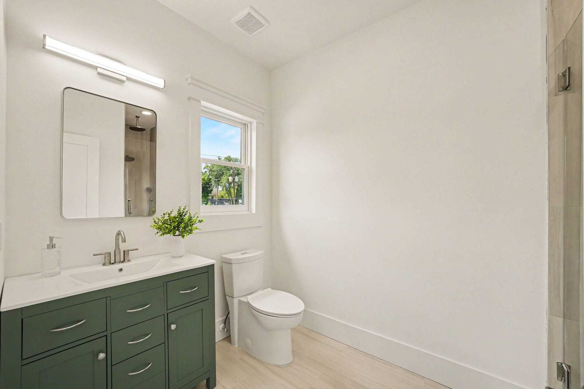Charming en-suite bathroom with gorgeous green design touches.