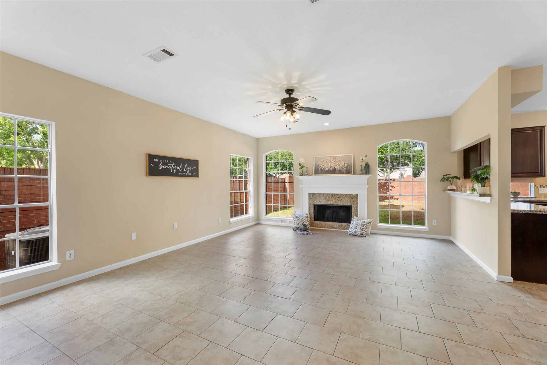 Cozy fireplace, tile flooring, and an open layout connecting to the kitchen. Perfect for family gatherings.