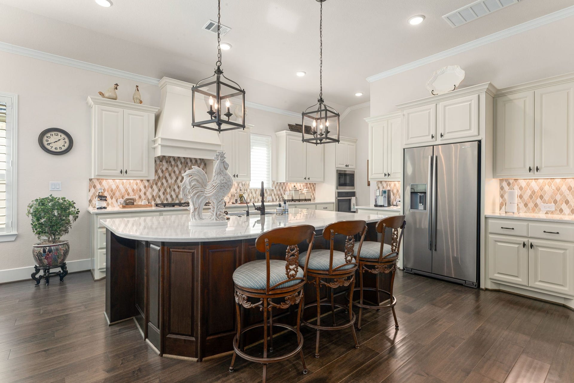 139 Dawning Rays Court, Conroe, TX 77304 A kitchen designed to impress! Featuring a spacious island with gorgeous quartz countertops, designer backsplash, custom cabinetry, stainless steel appliances, and stunning pendant lighting. Perfect for cooking, gathering, and entertaining!