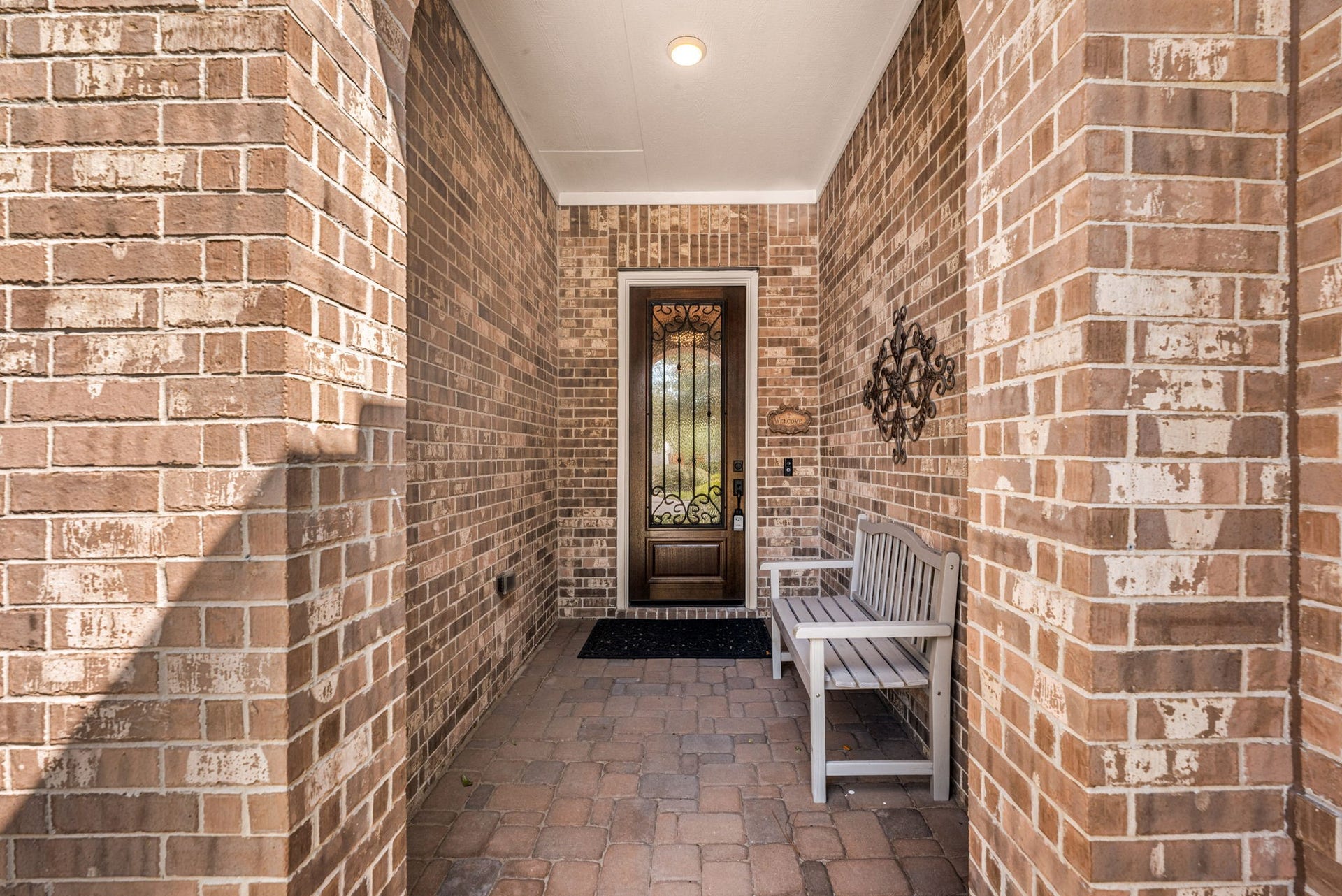 139 Dawning Rays Court, Conroe, TX 77304 Step inside this charming covered entry featuring beautiful brickwork, a welcoming sitting area, and an elegant front door with decorative wrought iron detailing!