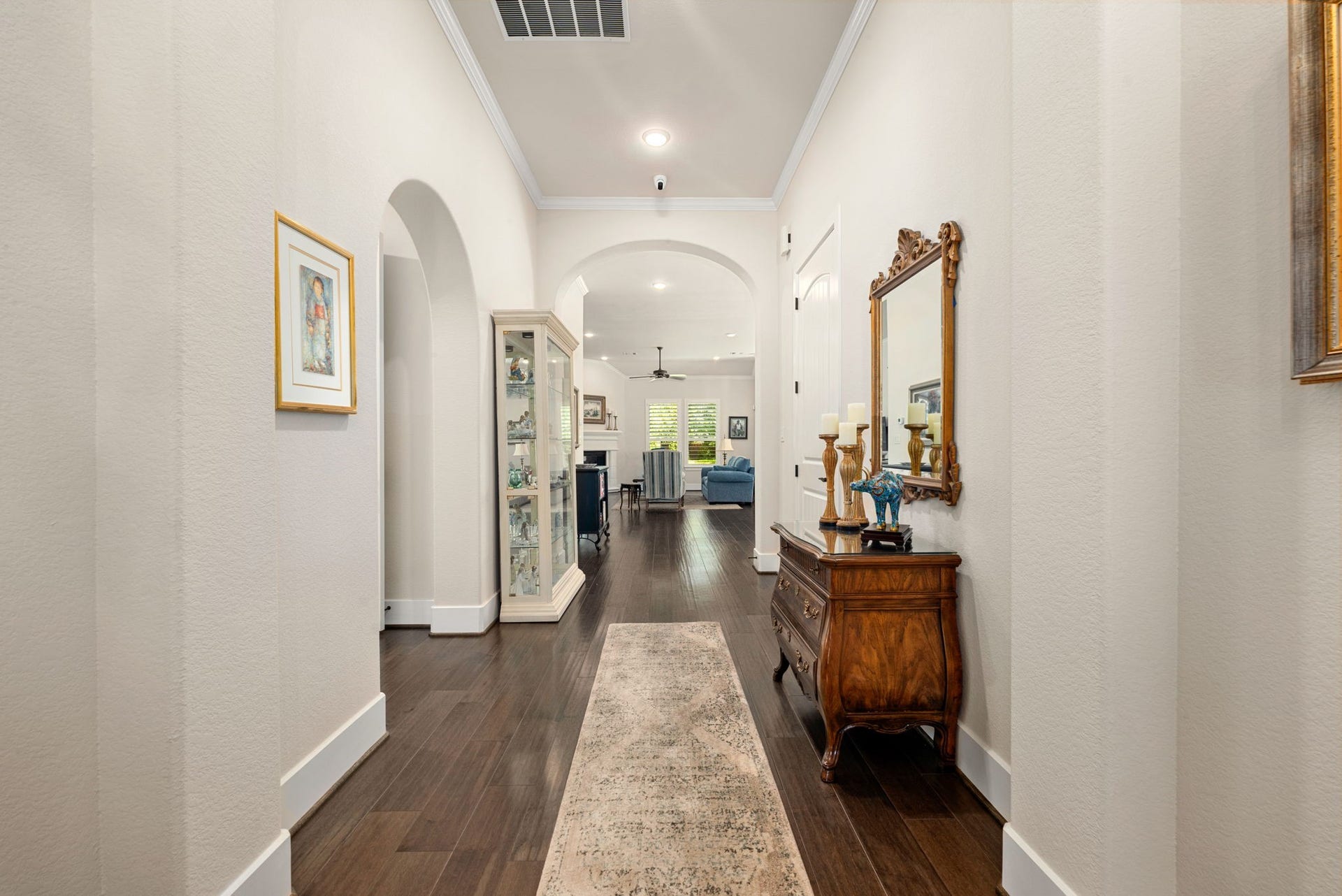 139 Dawning Rays Court, Conroe, TX 77304 Beautiful wood flooring and graceful archways lead you through the spacious entry and into the inviting living area, creating a wonderful sense of openness and flow!