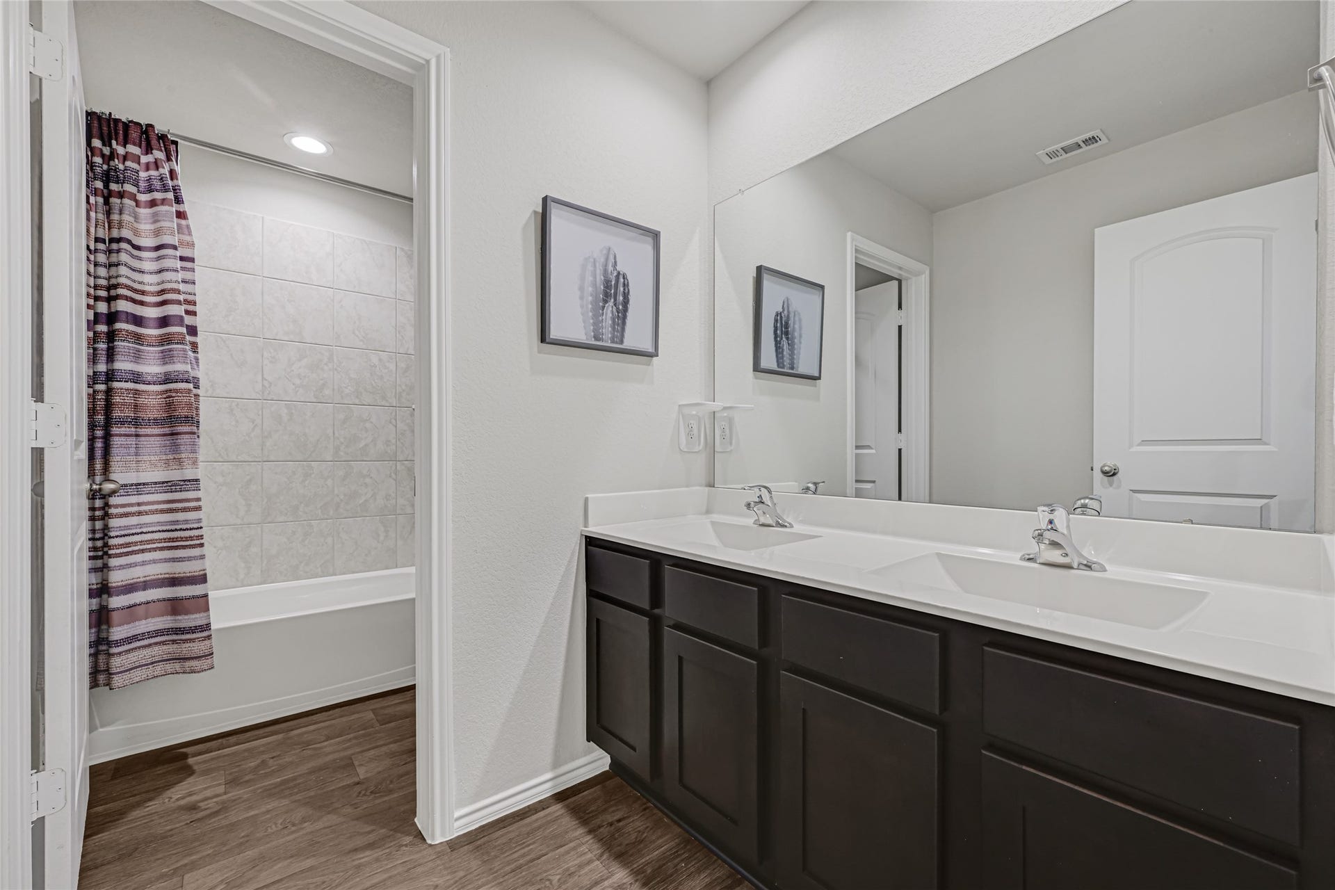 Full bath upstairs with dual sinks.