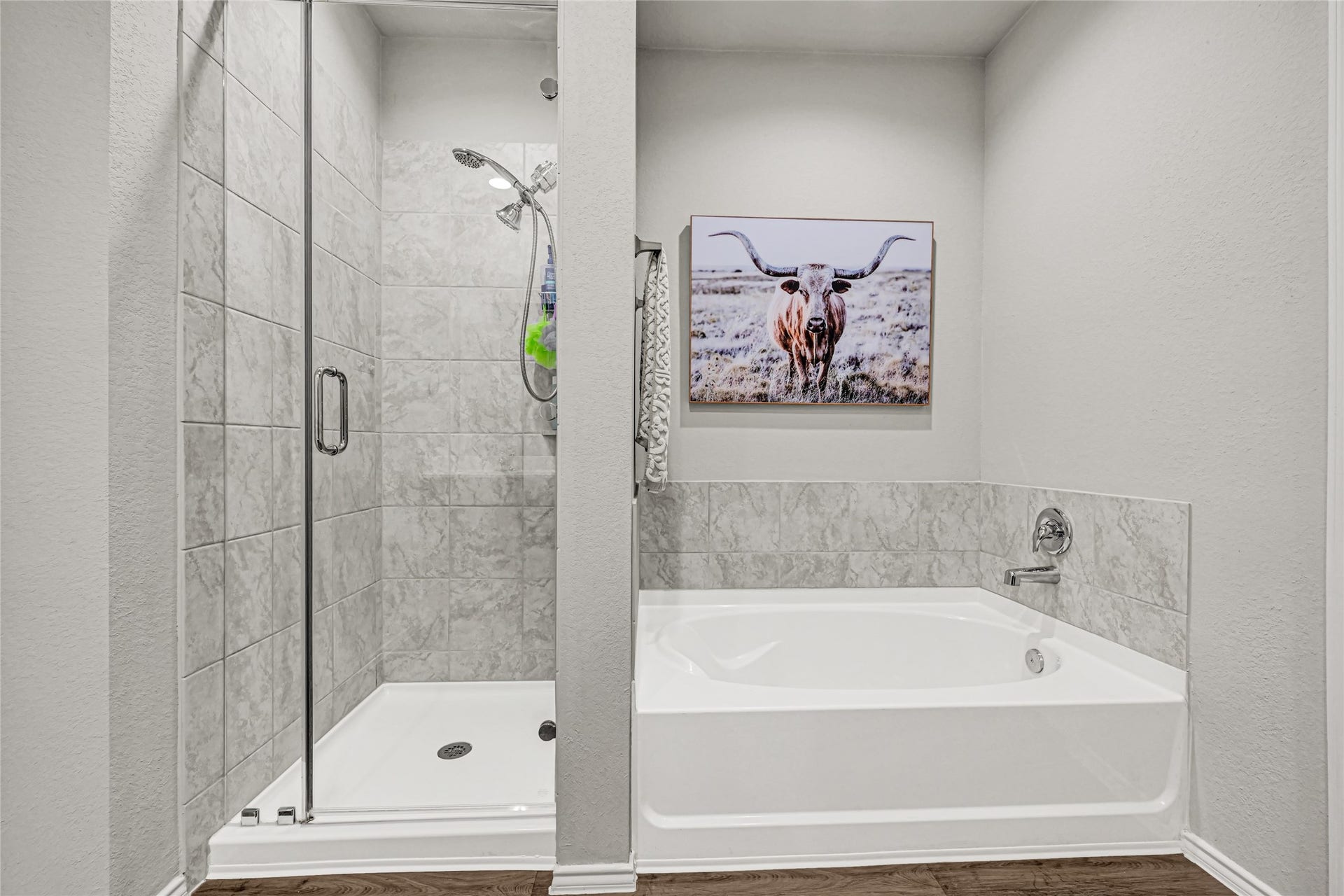 Primary bath with large soaking tub and separate shower.