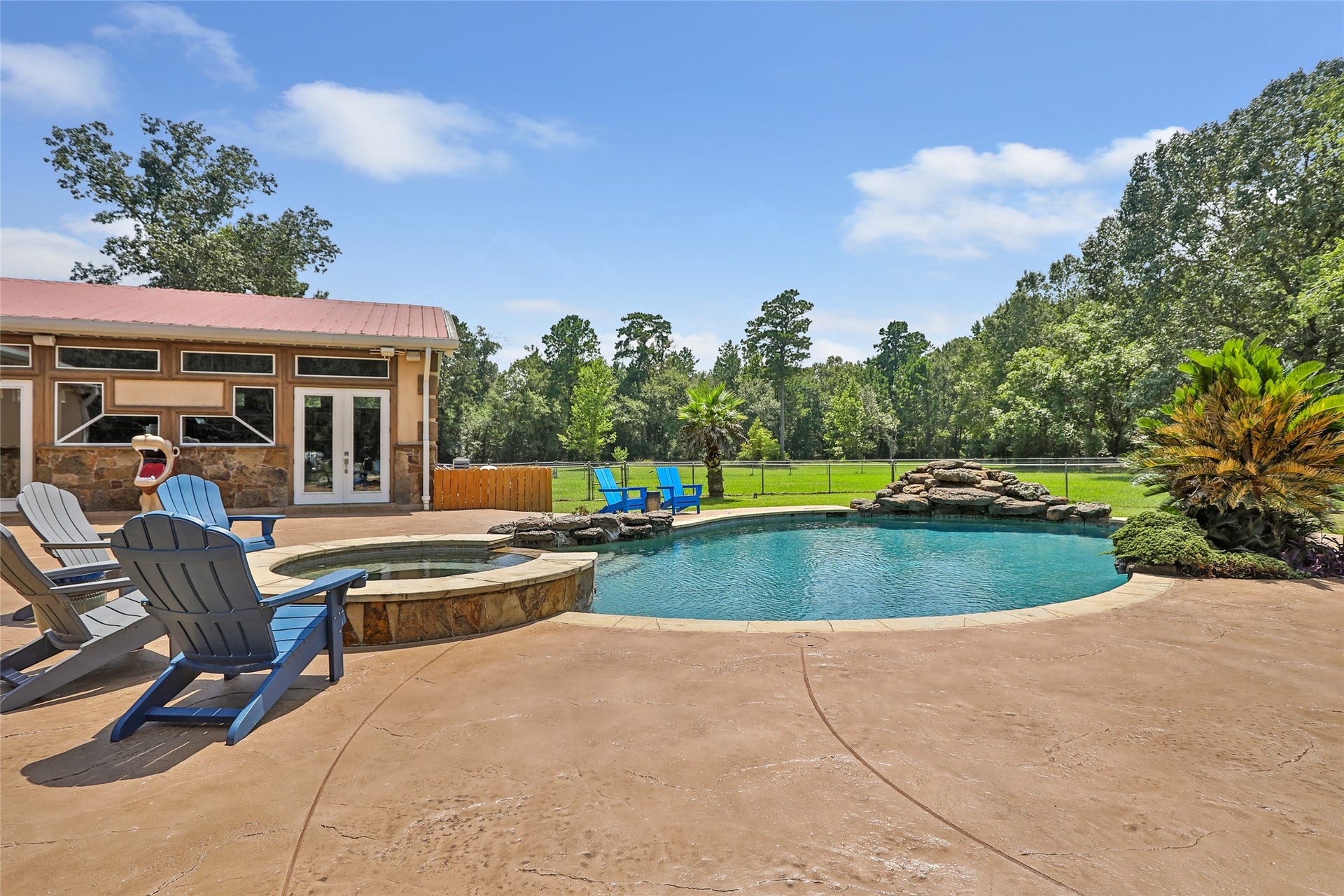26342 Hill And Dale Avenue, Splendora, TX 77372 Pool with hot tub and rock water feature.