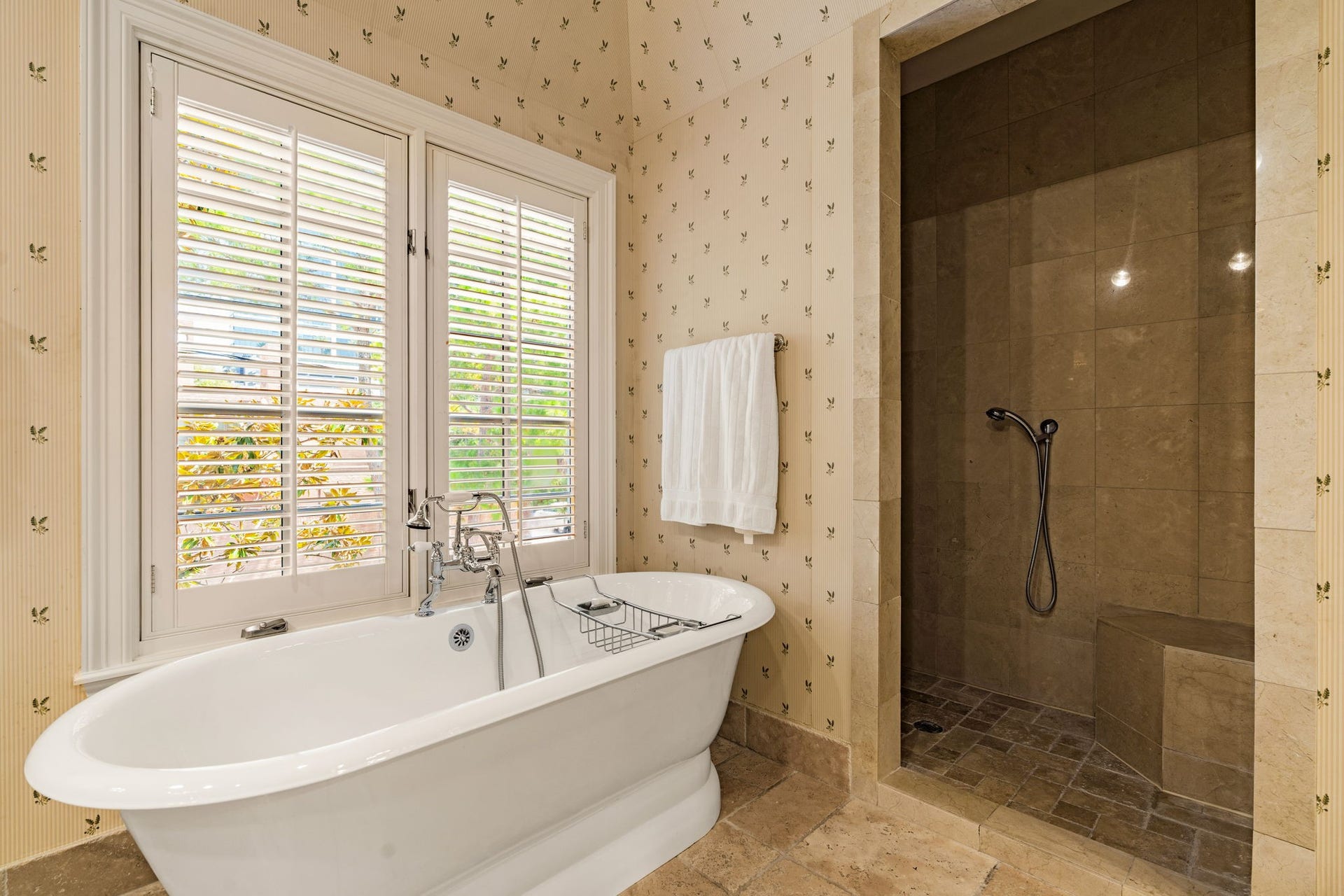 2820 Ferndale Street, Houston, TX 77098 Primary Bath: The walk-in shower features frameless glass, marble tile, and a multi-function hand-held spray system. It offers a clean, classic design.