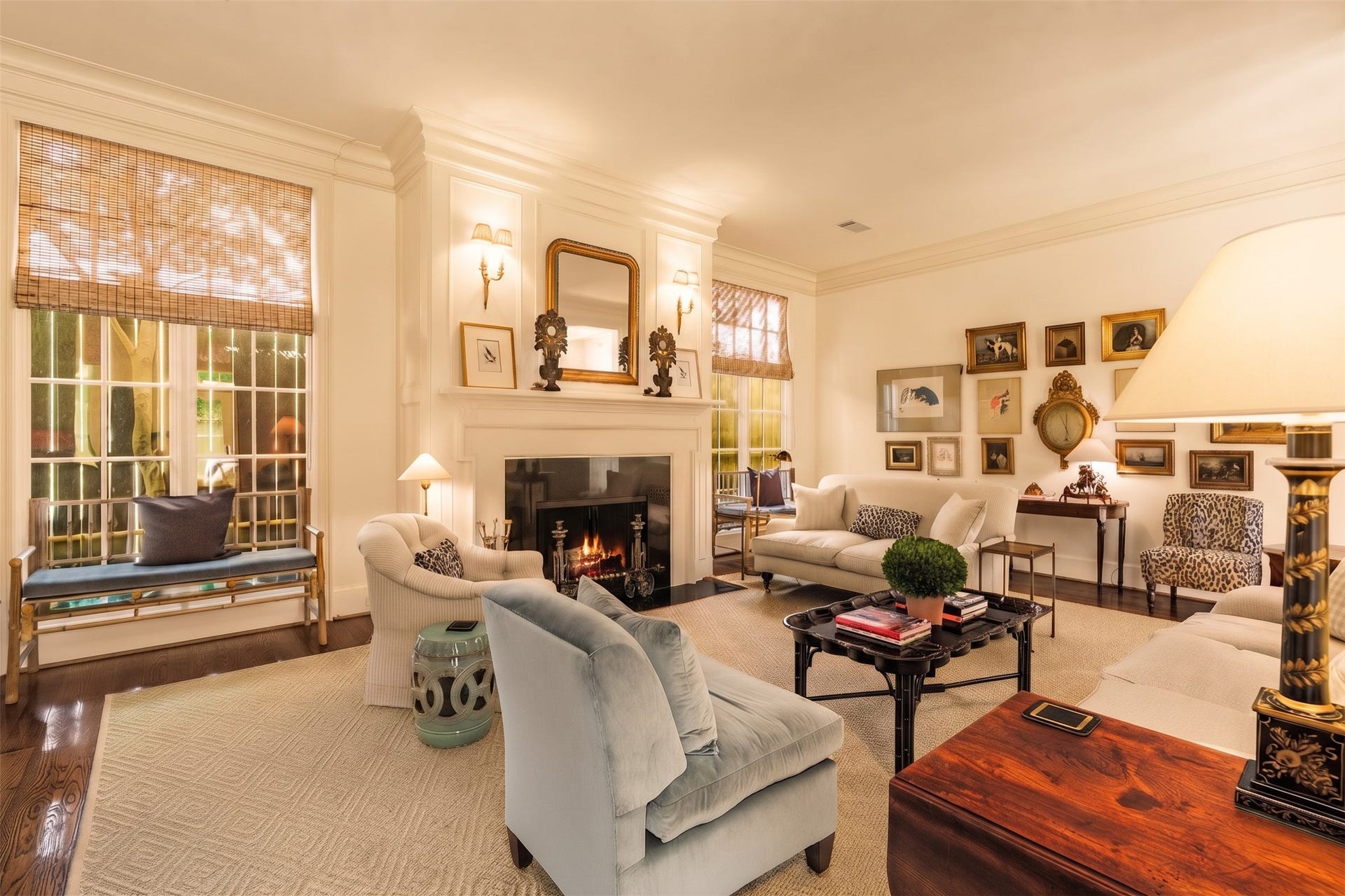 2820 Ferndale Street, Houston, TX 77098 Formal Living Room: Anchored by a wood-burning fireplace, the principal living room features refined hardwood floors framed by intricate moldings. Large windows bring in natural light while perimeter walls preserve interior privacy.