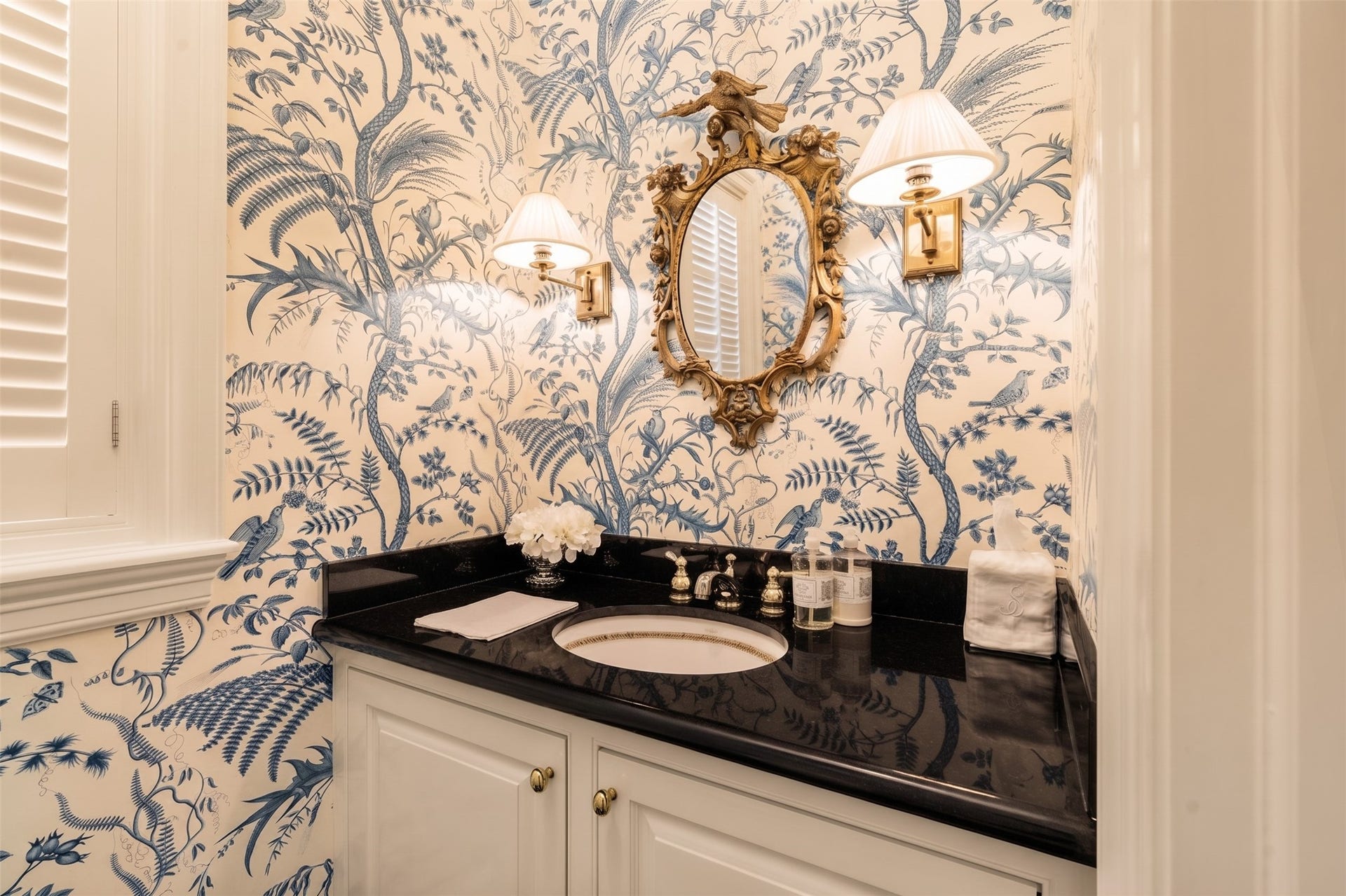2820 Ferndale Street, Houston, TX 77098 Ground-Floor Powder Room: The main-level half bath features stone surfaces, upgraded fixtures, and classic wall finishes. Situated discreetly for guests just off the main living spaces.