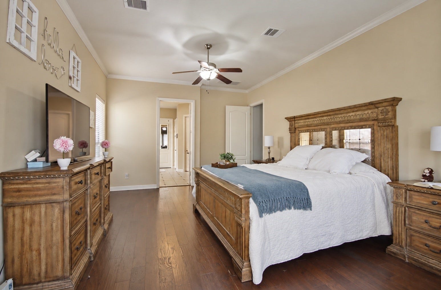 Primary bedroom has double doors that lead into the primary bathroom.