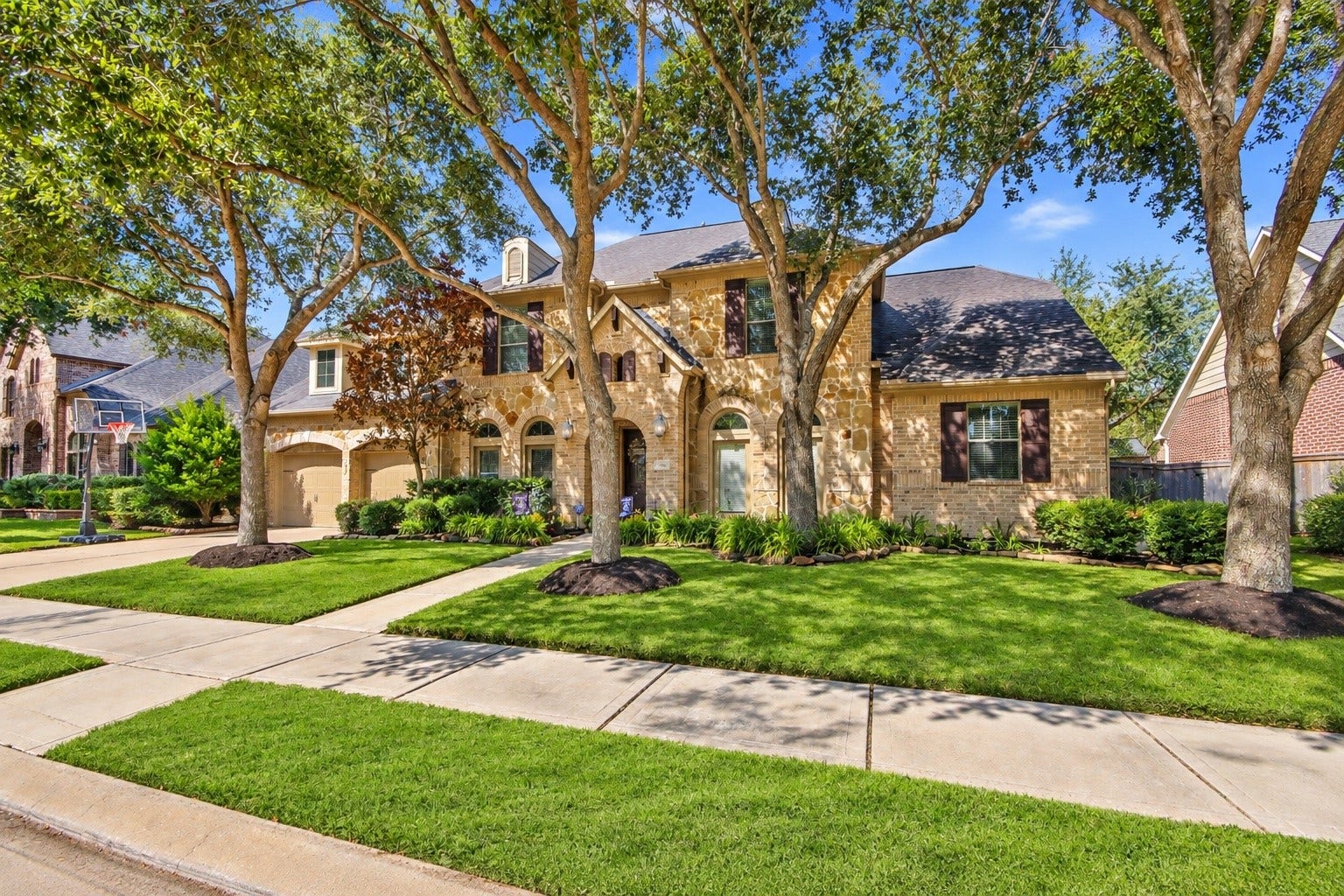 A well manicured lawn with mature trees to bring shade and comfort to the home.