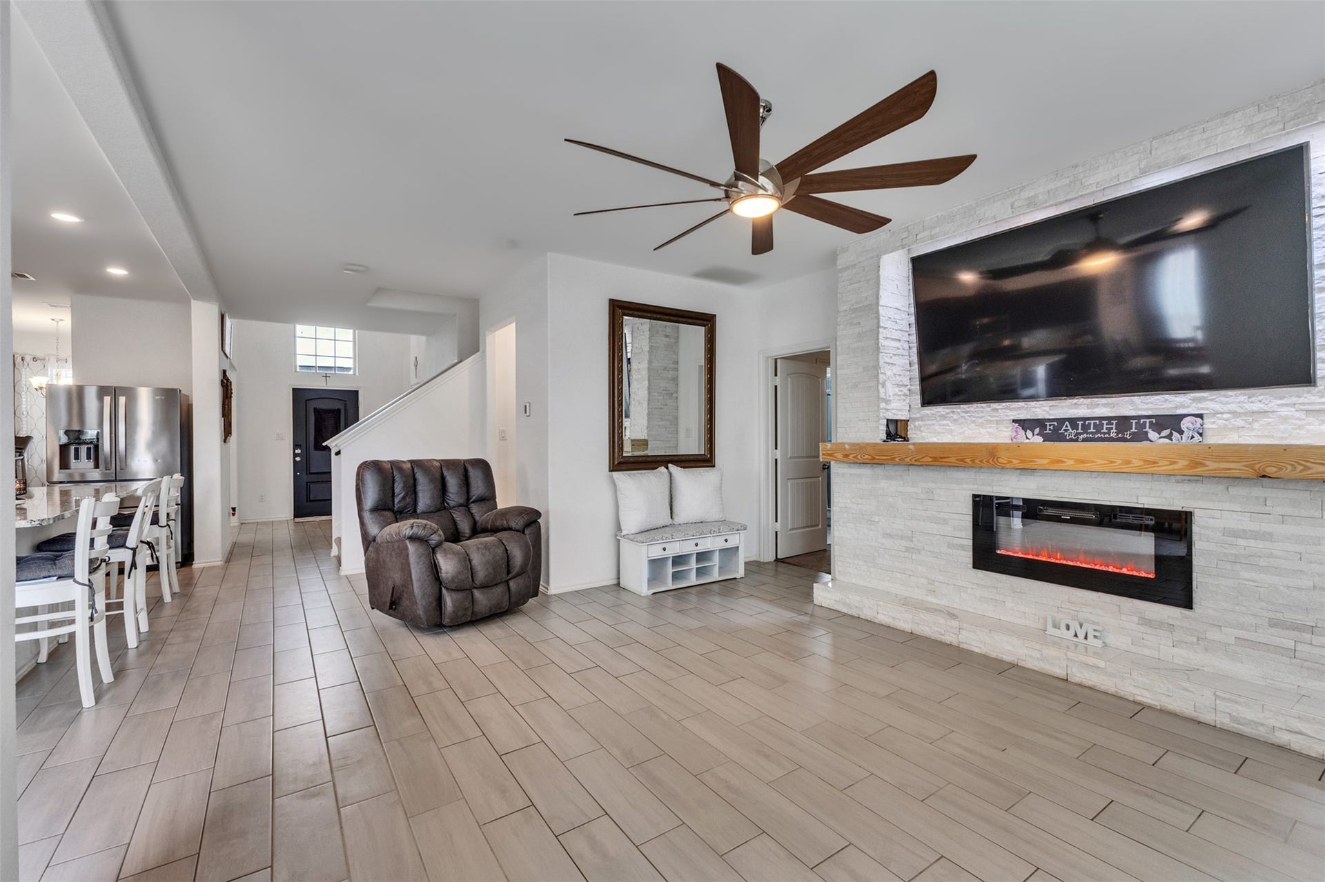 4341 Mocking Run Lane, Dickinson, TX 77539 This 82-inch Tv stays!!! The remote-control fireplace features color changing flames. You may also select heat ofr just ambient flames.