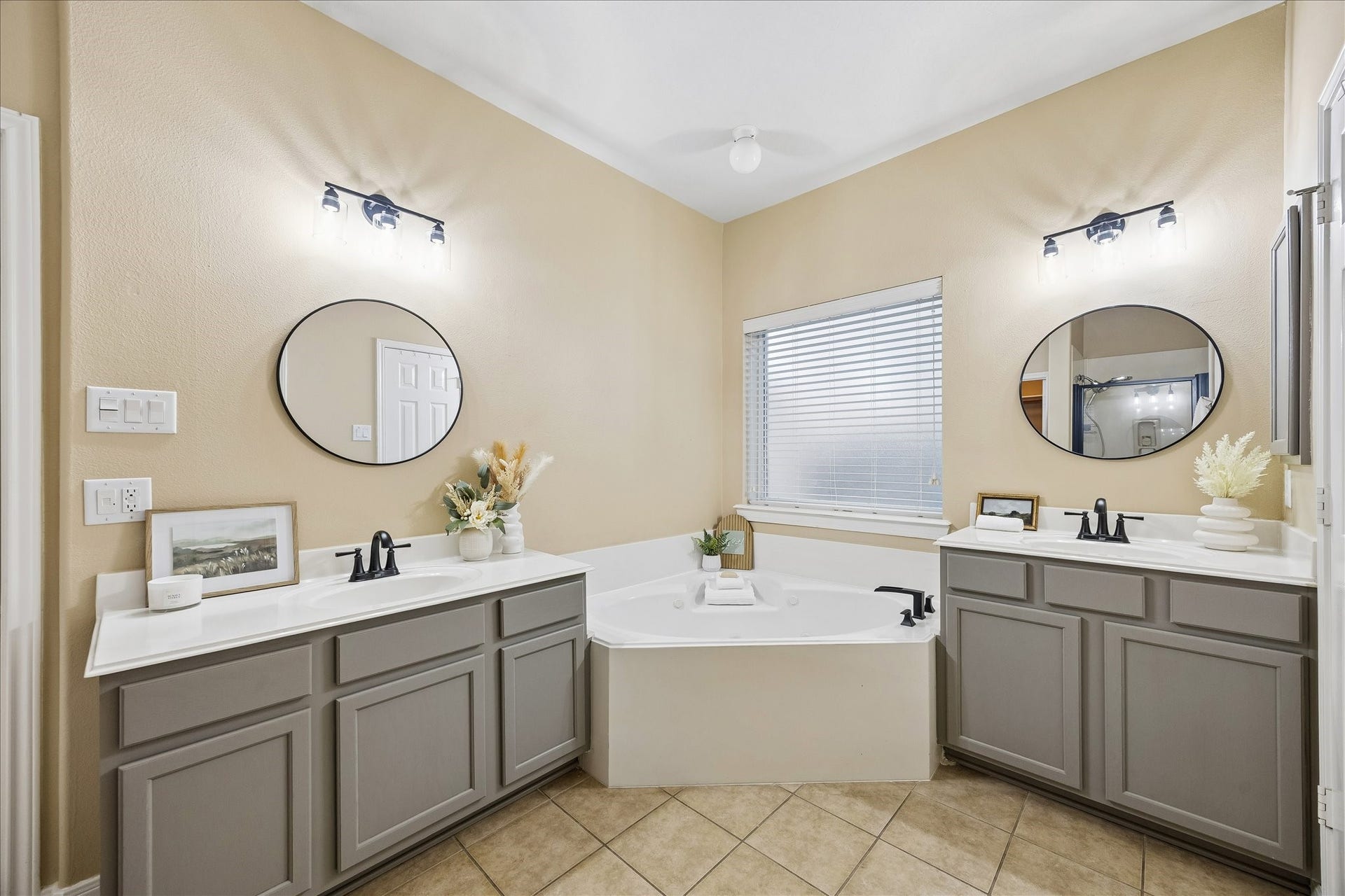 Dual vanities, soaker tub, & separate shower in the newly updated primary en-suite bath.