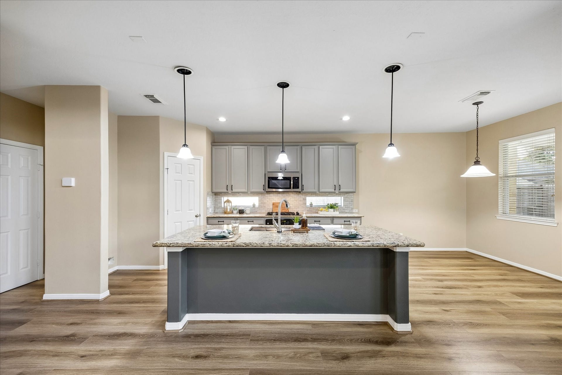 Breakfast bar opens to large family room.