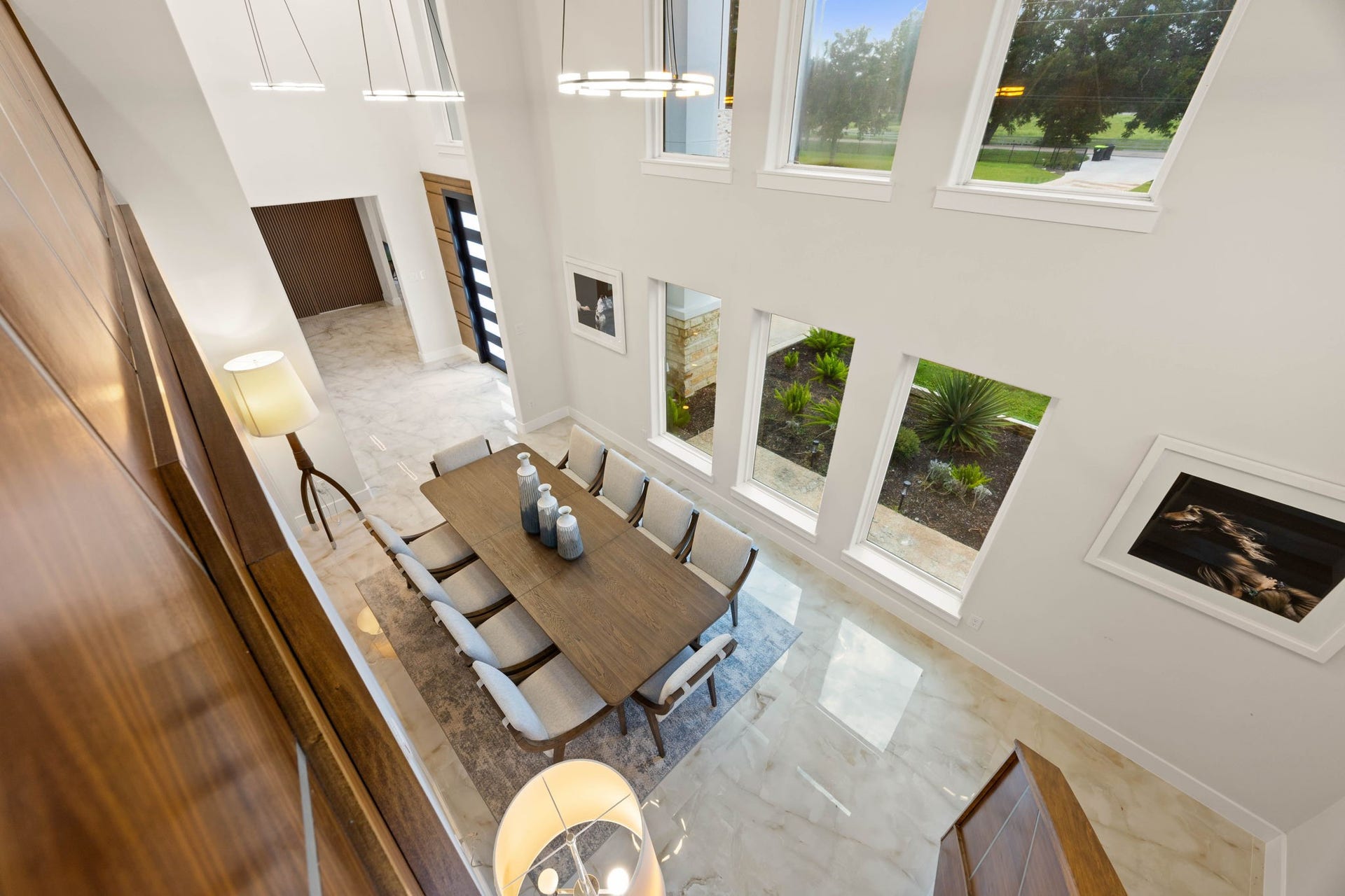 6830 Bois D Arc Lane, Fulshear, TX 77406 From the upstairs landing, the view stretches down over the dramatic two-story dining space and entry below, a striking look at the home's open, light-filled design.