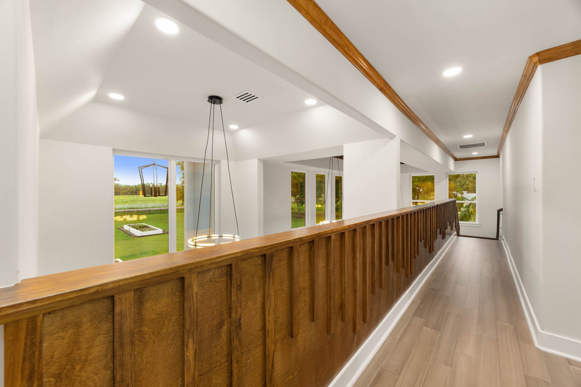 6830 Bois D Arc Lane, Fulshear, TX 77406 Imported wood paneling lines the upstairs hallway, adding warmth and craftsmanship to every sightline throughout the home.