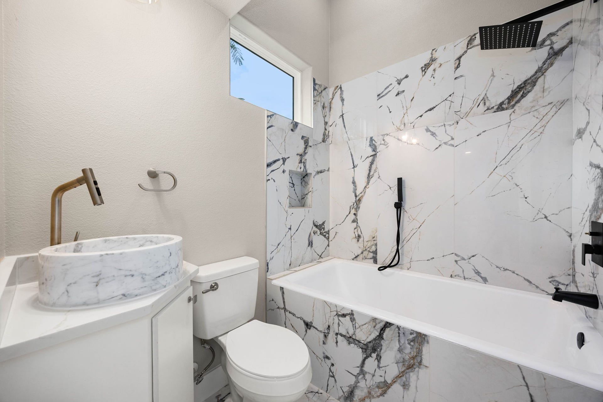 6830 Bois D Arc Lane, Fulshear, TX 77406 The suite's private bathroom features a marble vessel sink, a soaking tub, and a rainfall shower.