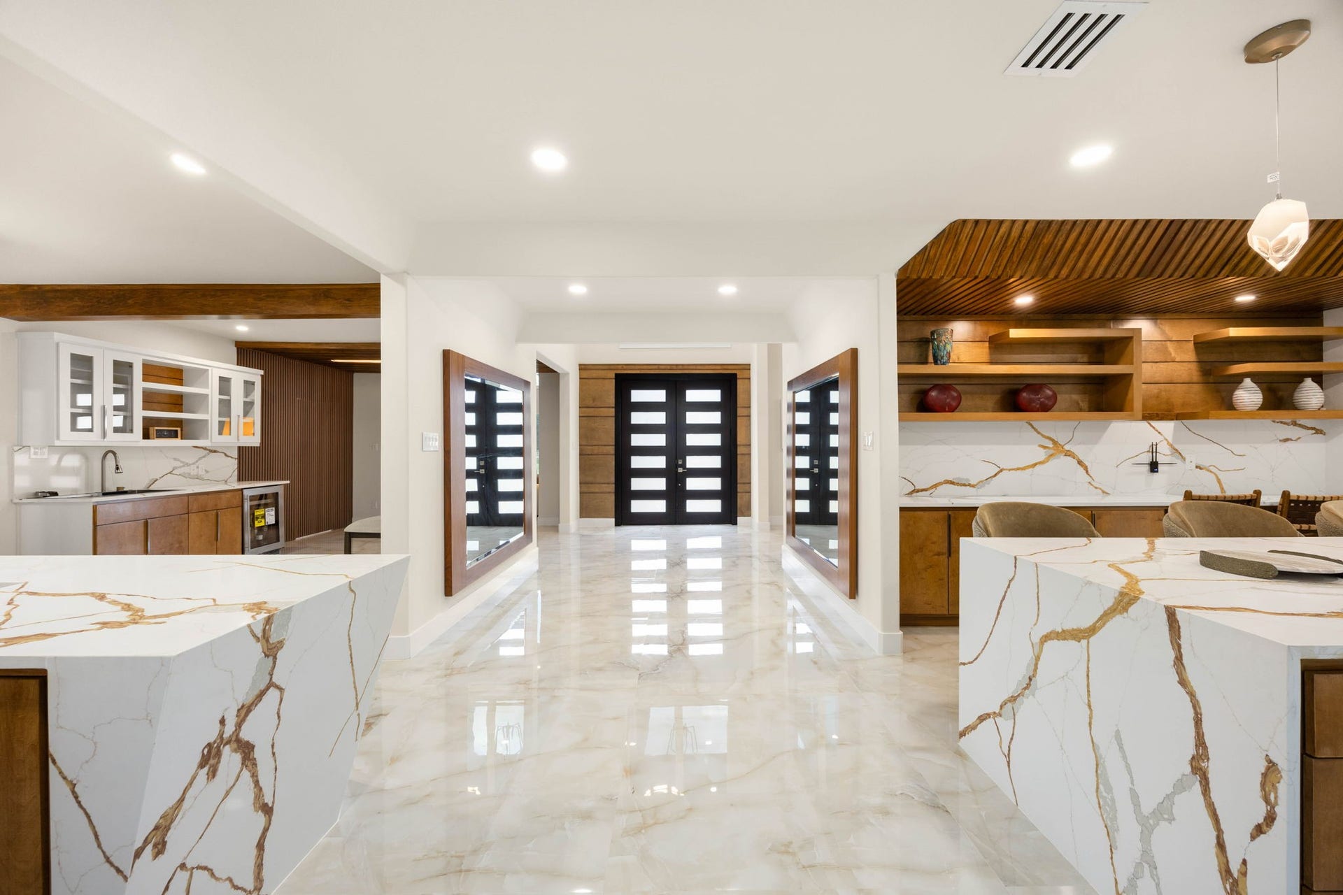 6830 Bois D Arc Lane, Fulshear, TX 77406 From the front doors, the view stretches straight through the marble-clad entry to the kitchen's two oversized islands beyond.