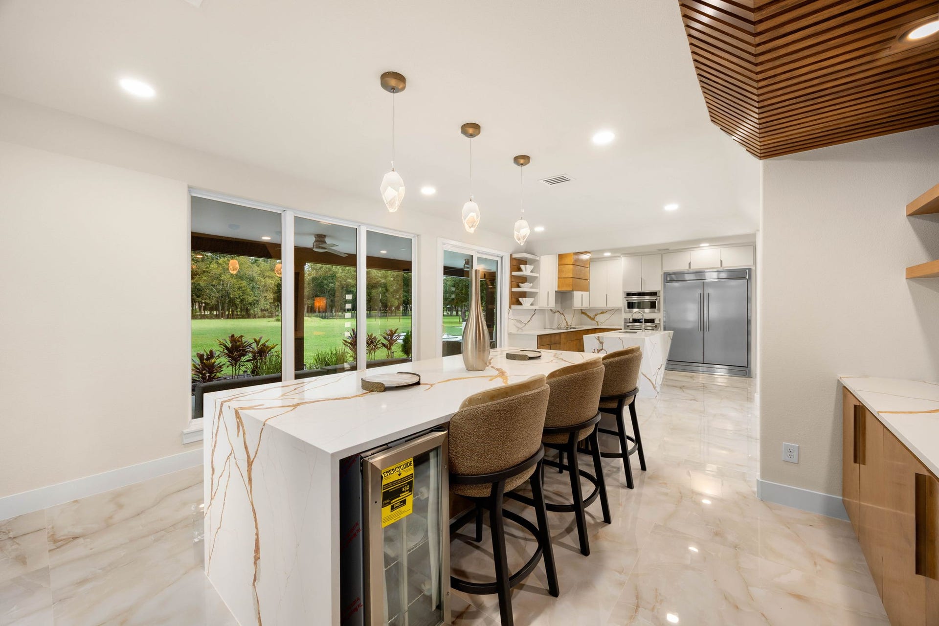 6830 Bois D Arc Lane, Fulshear, TX 77406 A row of counter seating overlooks the backyard, making this bright breakfast nook a favorite spot to start the day.