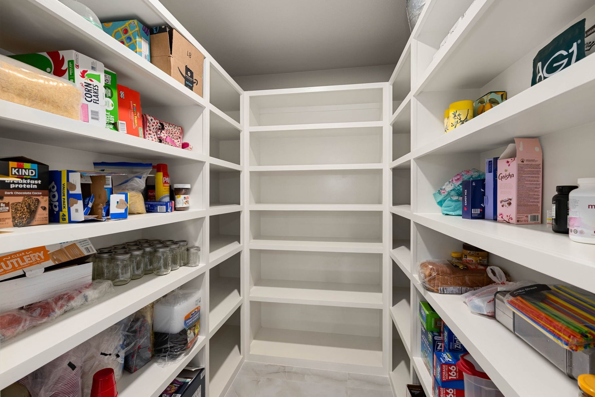 6830 Bois D Arc Lane, Fulshear, TX 77406 A spacious walk-in pantry offers floor-to-ceiling shelving with room to store everything from everyday staples to entertaining essentials.