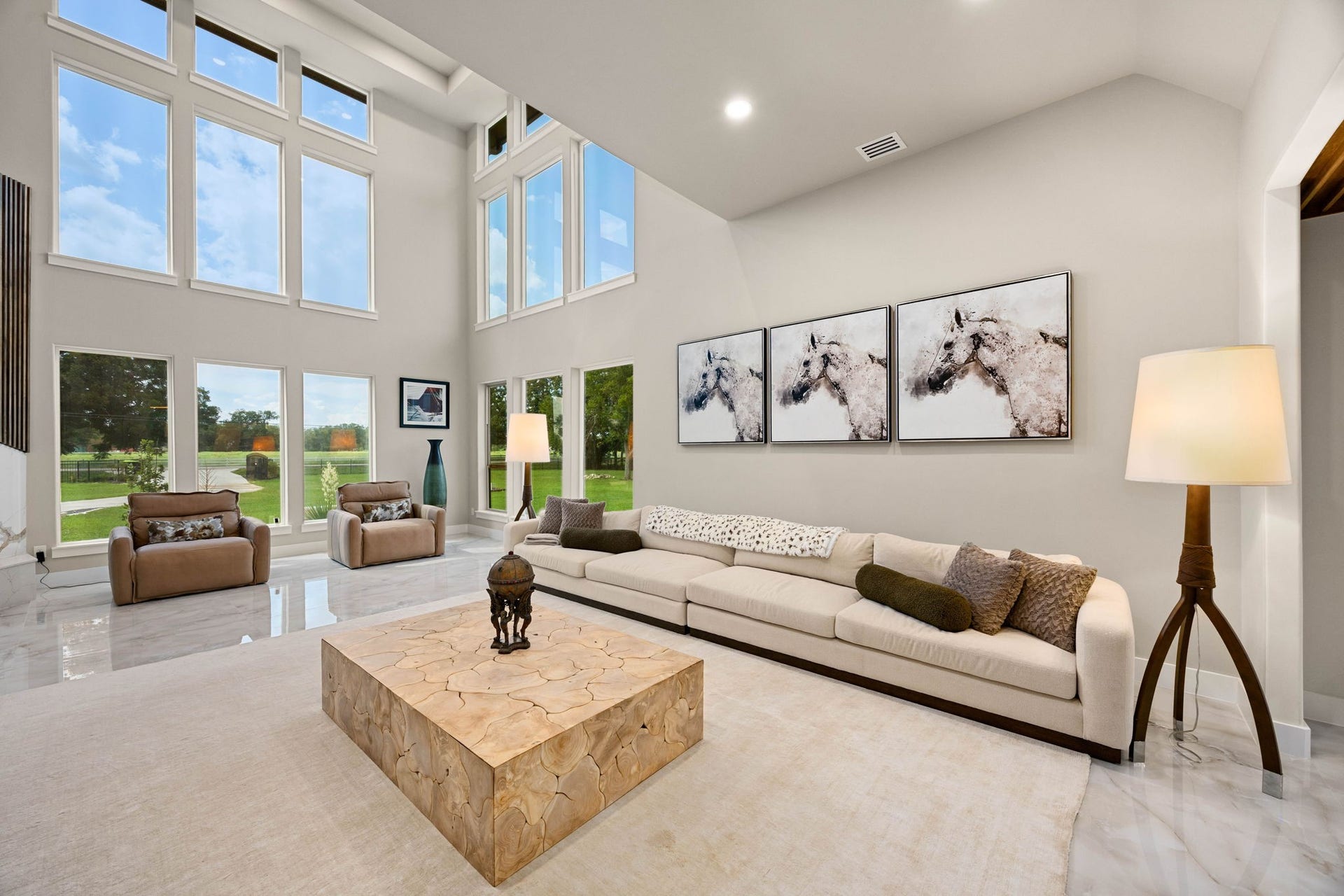 6830 Bois D Arc Lane, Fulshear, TX 77406 Two-story windows flood the living area with natural light, while one of the home's two fireplaces adds warmth beneath soaring ceilings.