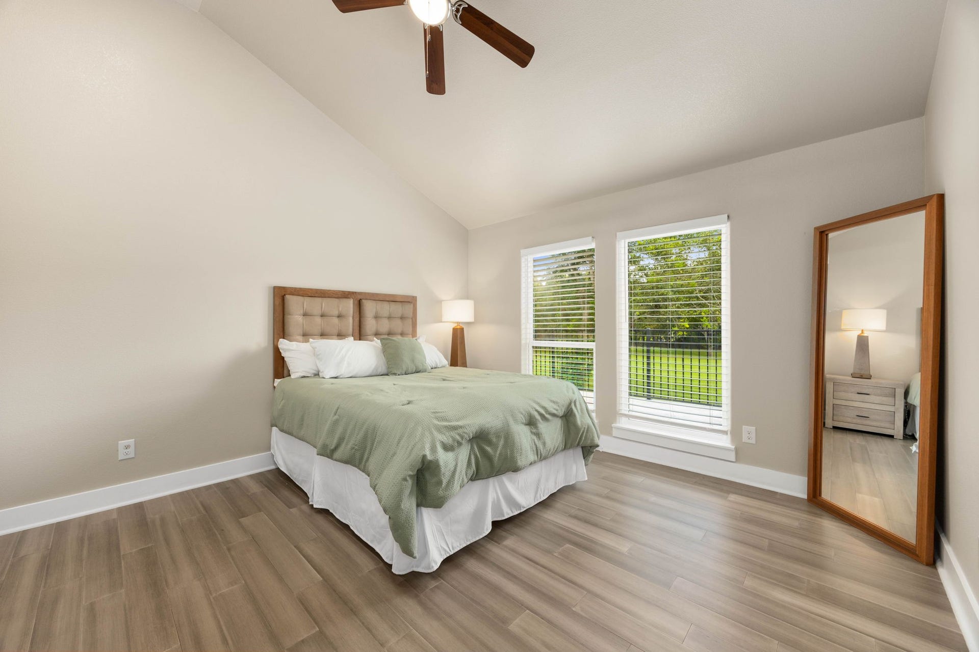 6830 Bois D Arc Lane, Fulshear, TX 77406 Another secondary bedroom features a vaulted ceiling, and two windows overlooking the covered patio.