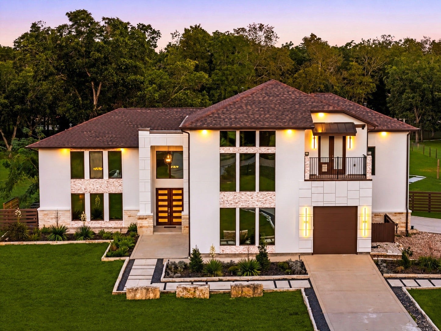 6830 Bois D Arc Lane, Fulshear, TX 77406 Welcome to more than 2.5 private acres in Fulshear, where every detail of this estate was custom-built, from the soaring glass faade to the stacked stone accents glowing at twilight.