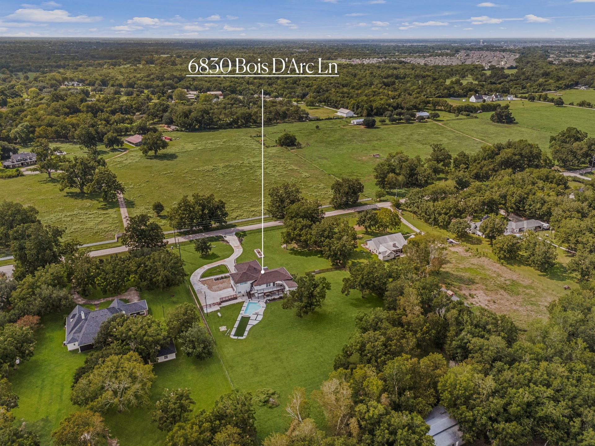 6830 Bois D Arc Lane, Fulshear, TX 77406 Set back from the road amid mature trees, 6830 Bois D'Arc Ln offers a private, spacious setting in Fulshear.