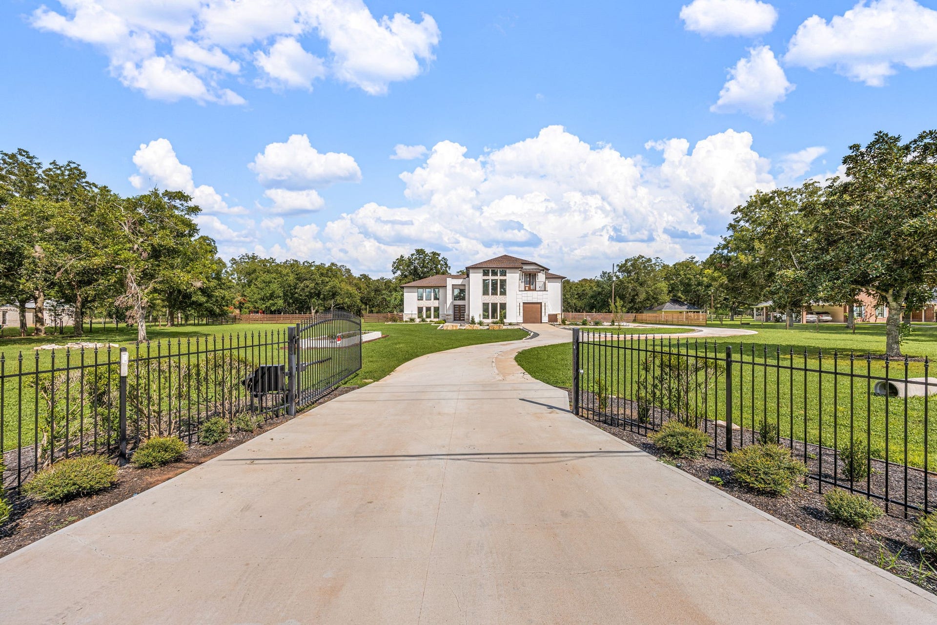6830 Bois D Arc Lane, Fulshear, TX 77406 Privacy, scale, and an unmistakable sense of arrival define this estate, where an automated wrought-iron gate opens to a sweeping private drive and the residence beyond.