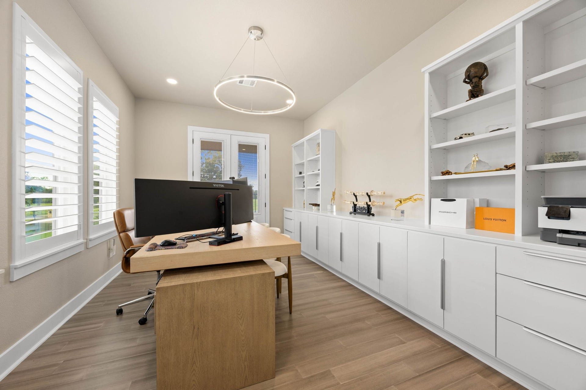 6830 Bois D Arc Lane, Fulshear, TX 77406 The office upstairs is finished with custom built-in shelving, a sleek desk, and abundant natural light from dual windows.