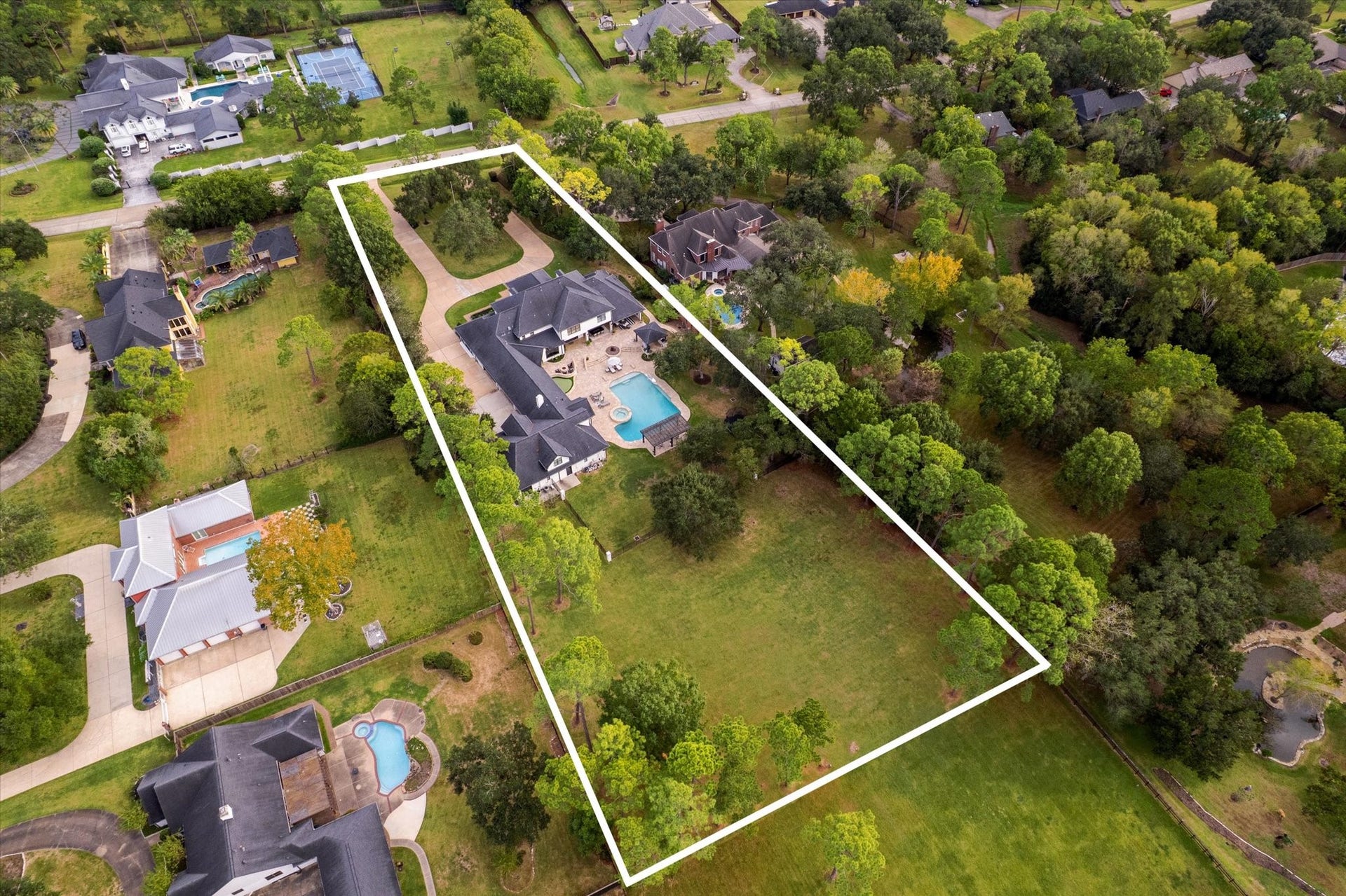 Situated on 2.23 acres, this exceptional property offers expansive green space and endless possibilities for outdoor recreations, a future tennis court, additional workshop of outbuilding, or simply enjoying the beauty of the sprawling grounds.