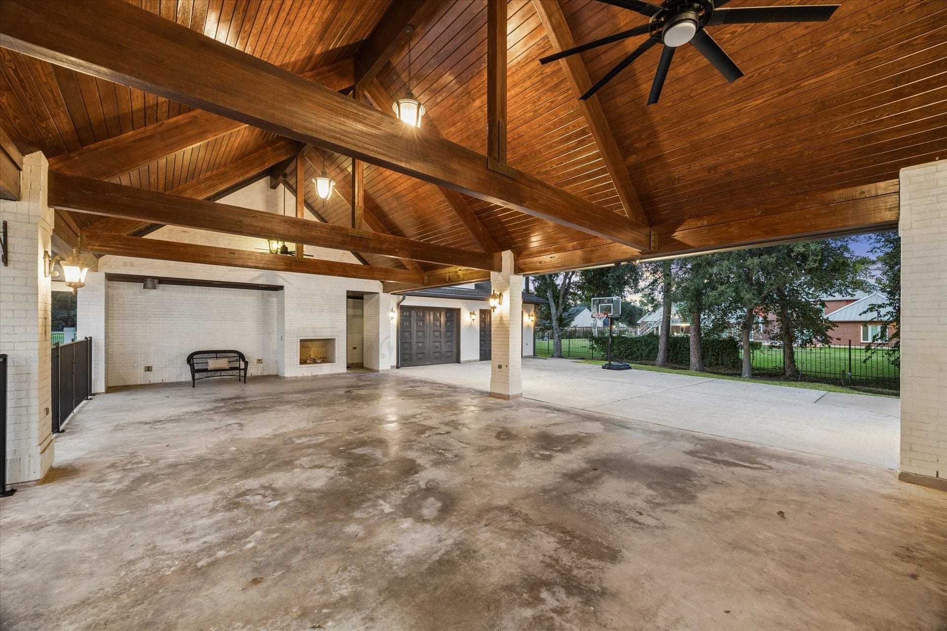 The porte-cochere allows for four cars and features a gas fireplace, access to the detached garage and second floor space.