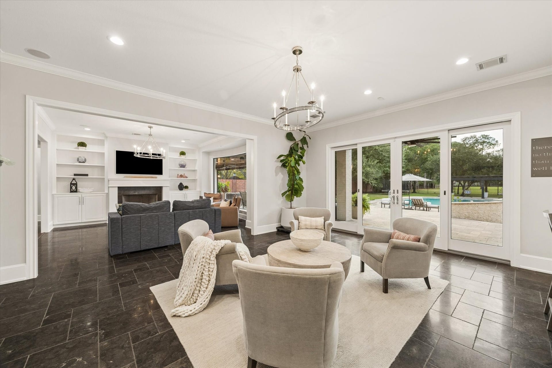 Sitting area transitioning between the living room and kitchen, featuring sliding glass doors that open to the patio and outdoor dining area.