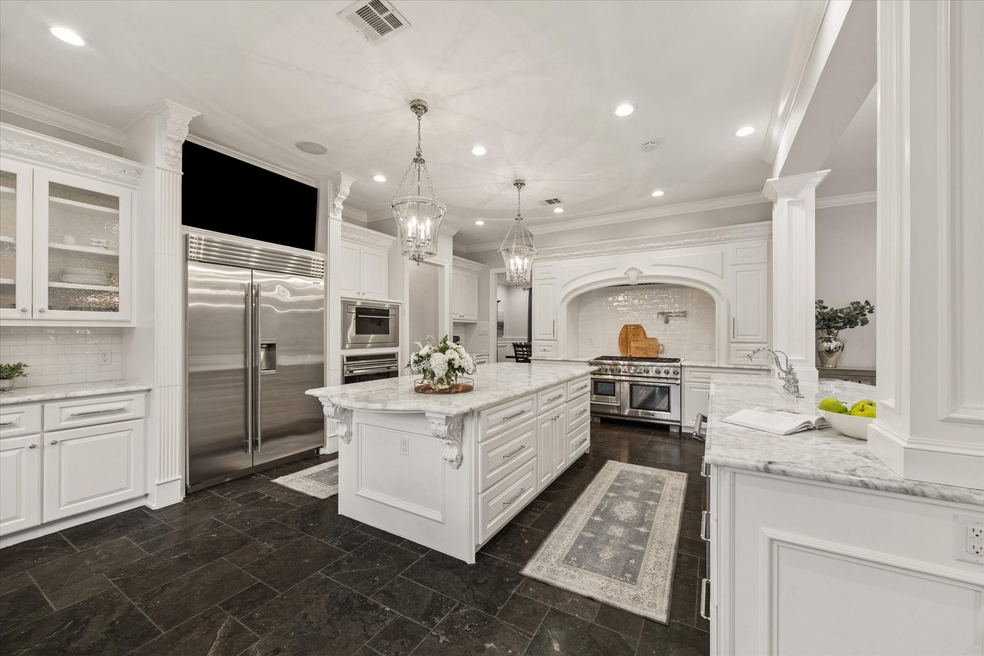 View of the kitchen featuring a built-in Sub-Zero refrigerator and integrated television.