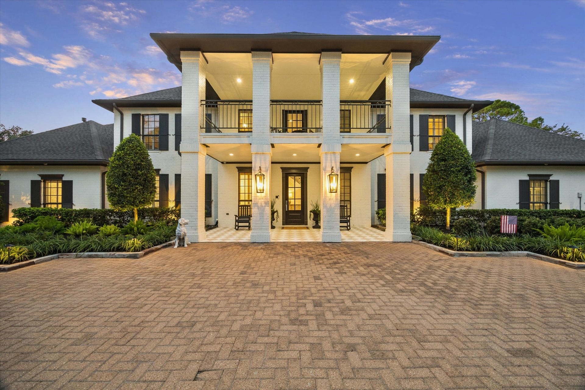 A grand, columned entrance welcomes you to this elegant estate, featuring a stately two-story covered portico, upper balcony, and expansive brick-paver entrance. Timeless Southern architecture and exceptional curb appeal create a string first impression.
