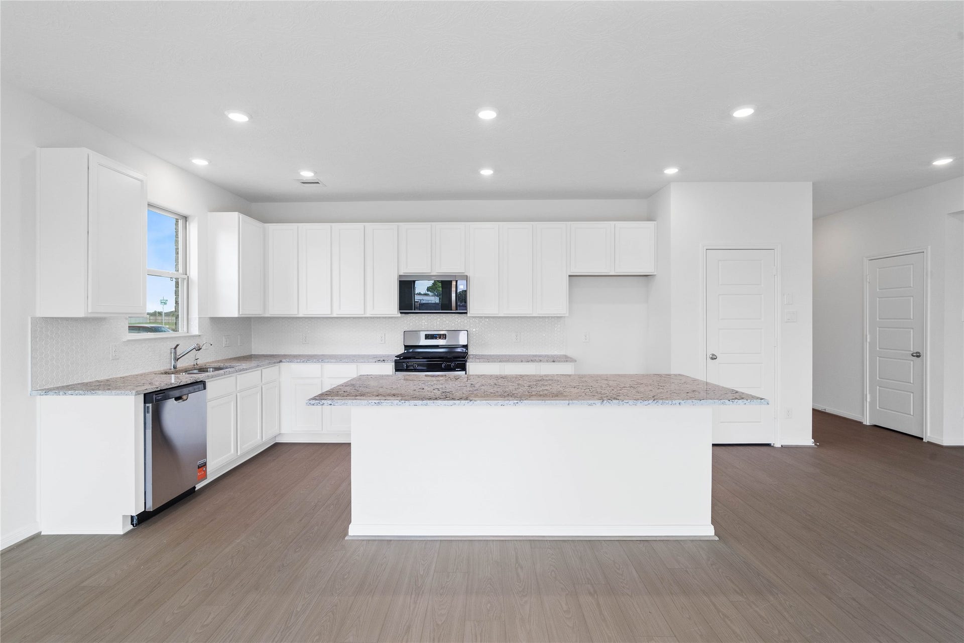 This gorgeous kitchen features a large kitchen island and added breakfast bar to kitchen countertop!