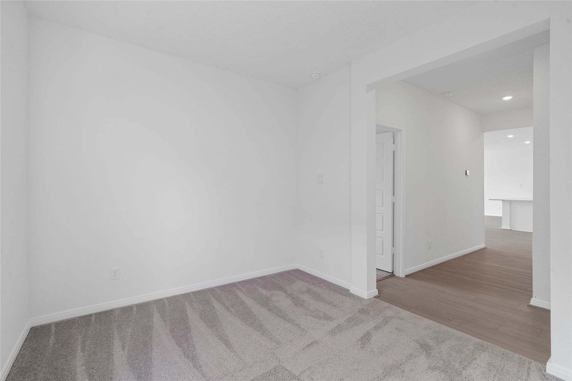 Additional view from Den into hallway. On the left is the entrance into the primary bedroom suite. The Great Room is beyond the hallway.