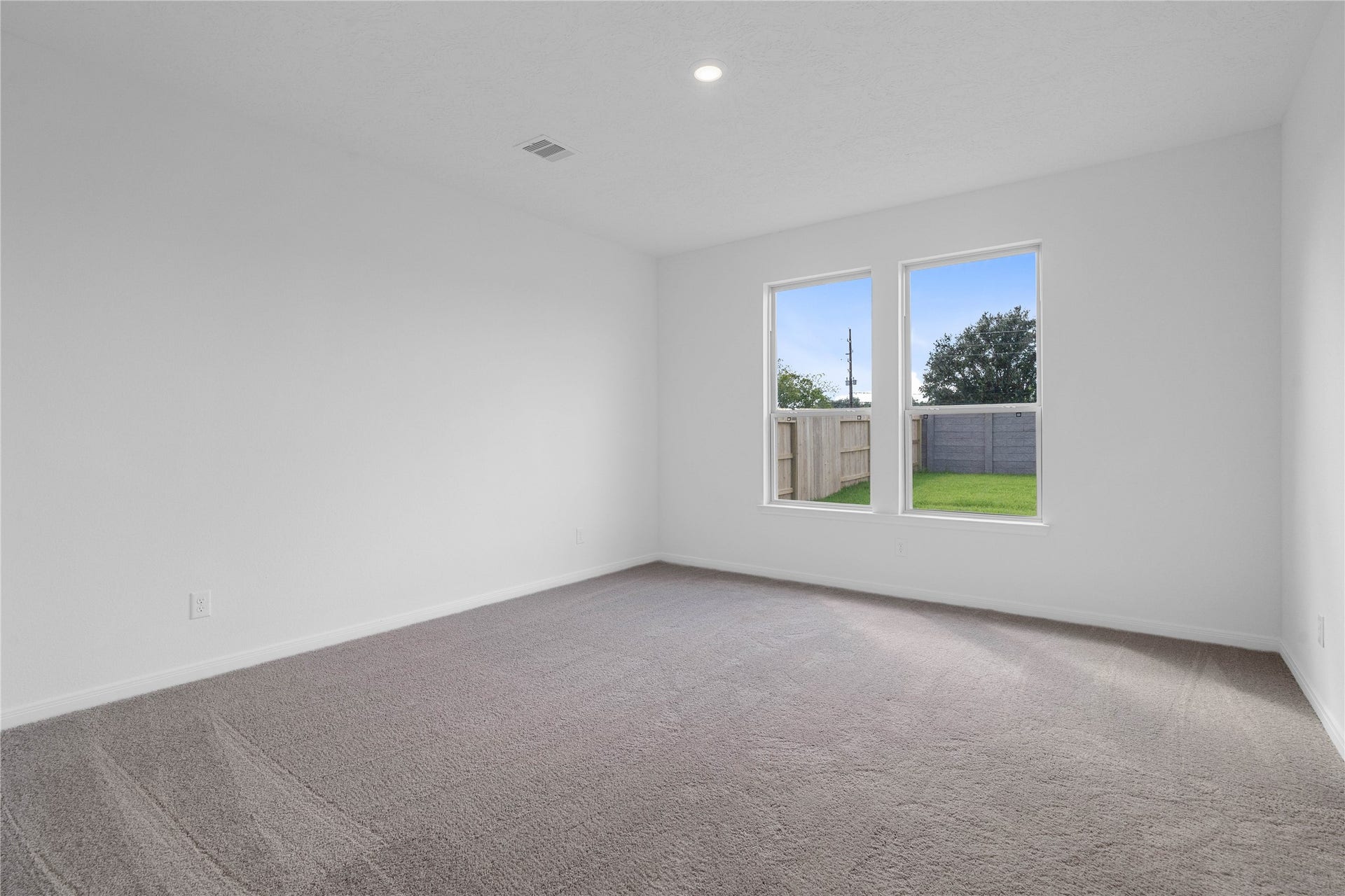 Come and unwind after a long day in this magnificent and spacious primary suite! This room features plush carpet, neutral paint, high ceiling, and large windows.