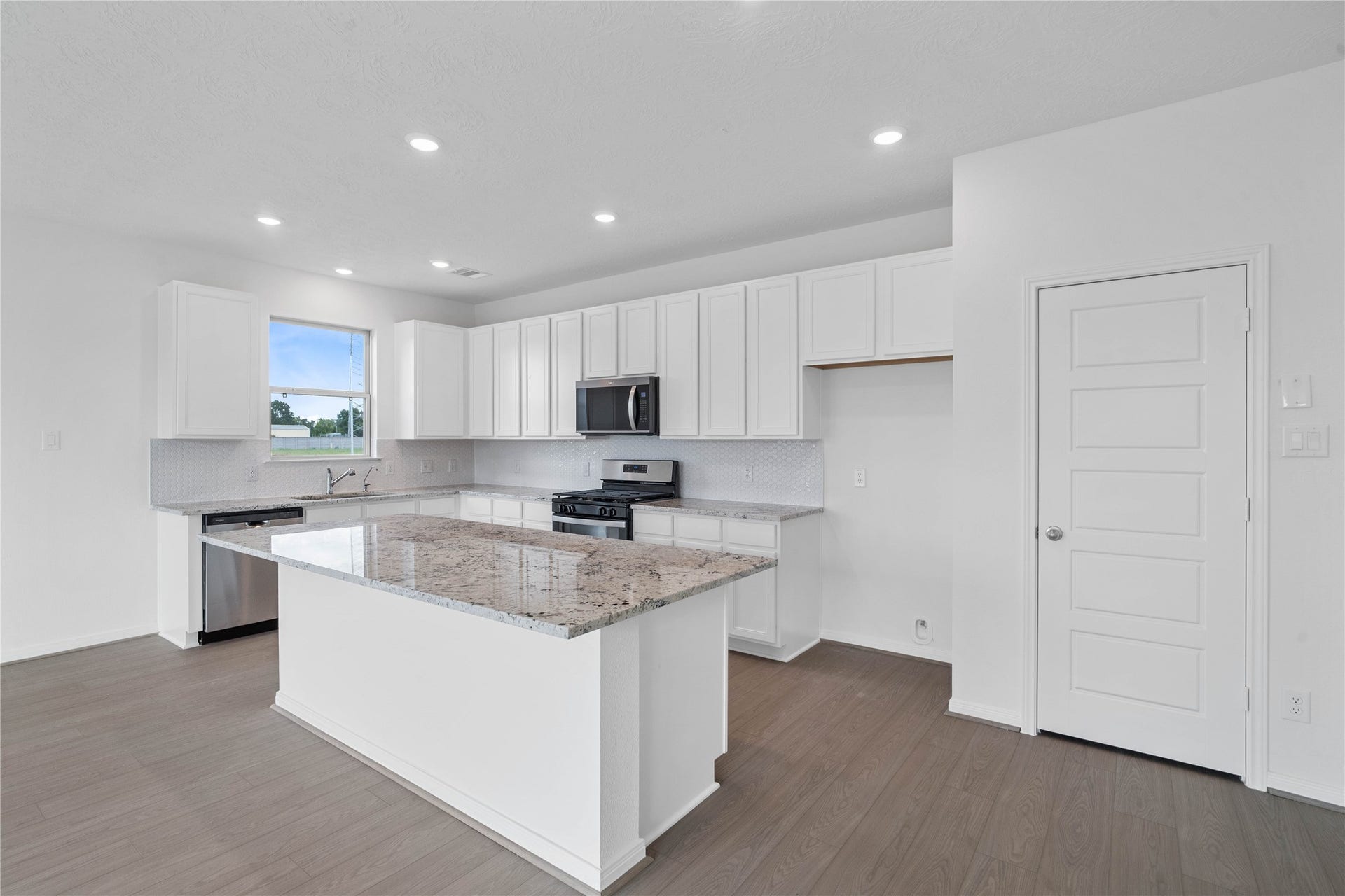 Beautiful view of the kitchen island with granite countertop, extended breakfast bar.