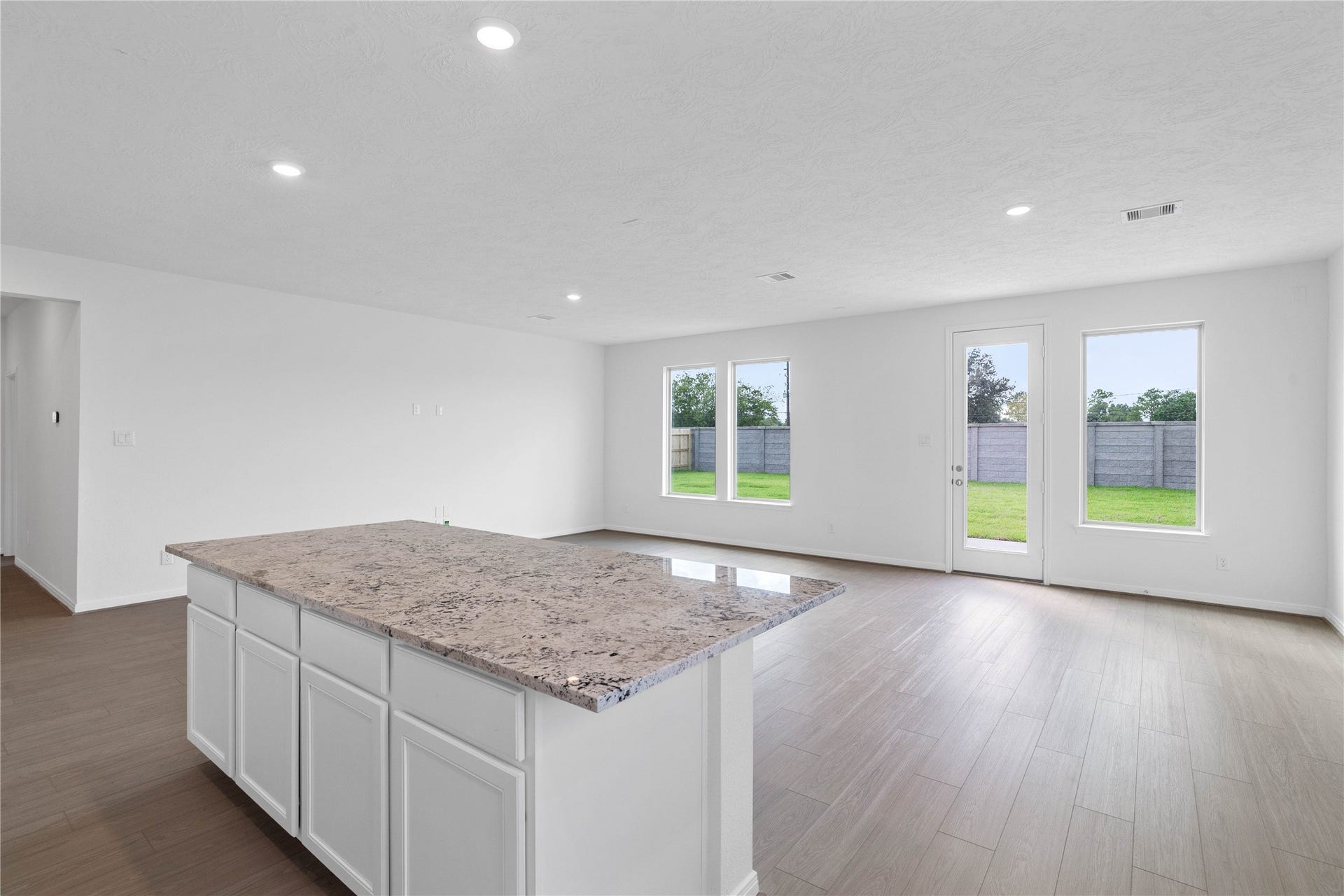 Enjoy a commanding view of the main floor from this perfectly positioned kitchen island, offering the ultimate setup for keeping an eye on the action. The central hub overlooks the expansive layout, making it easy to stay connected to guests or family while preparing meals.
