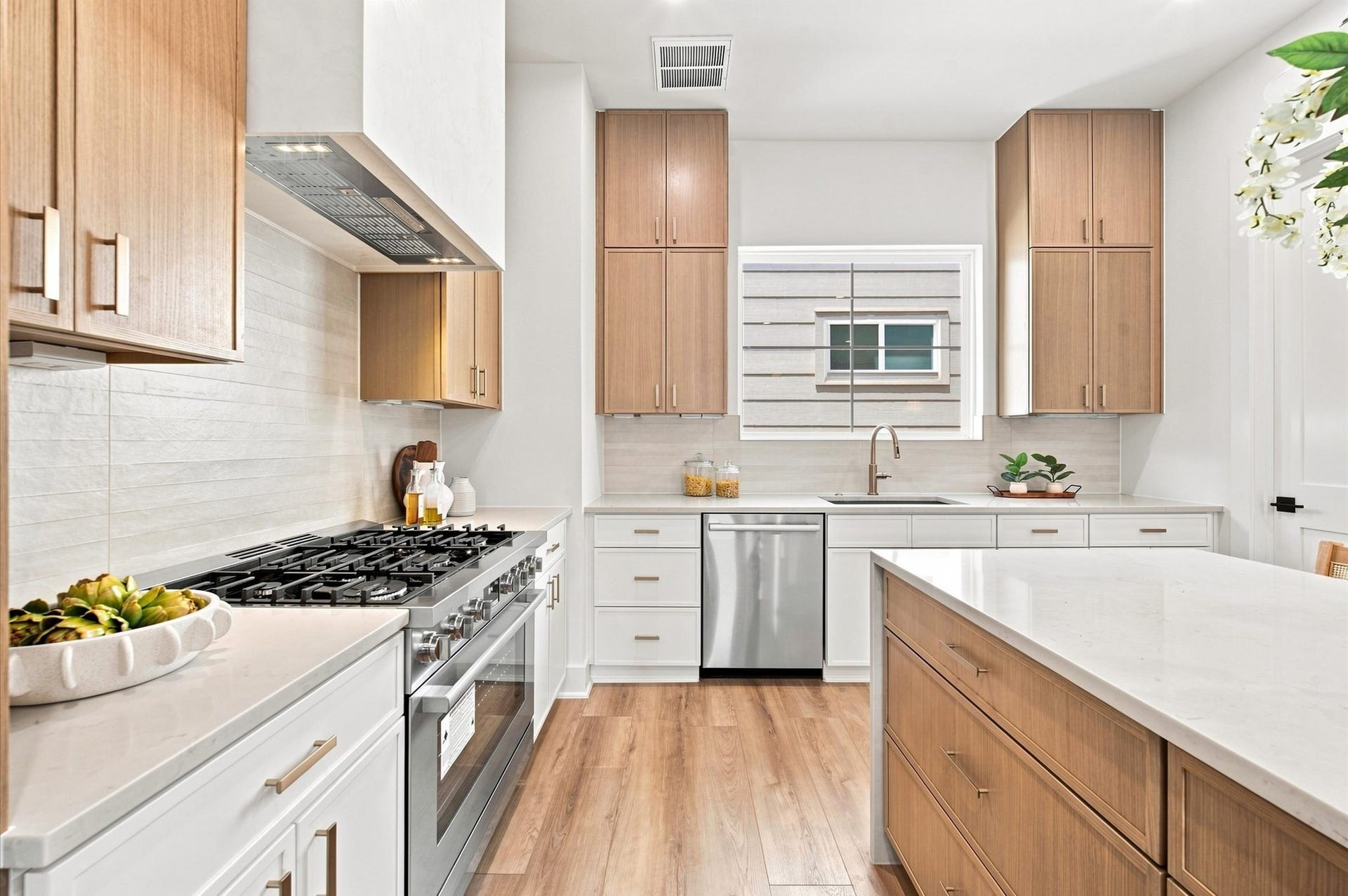 Gourmet kitchen features a waterfall island with quartz countertops.
